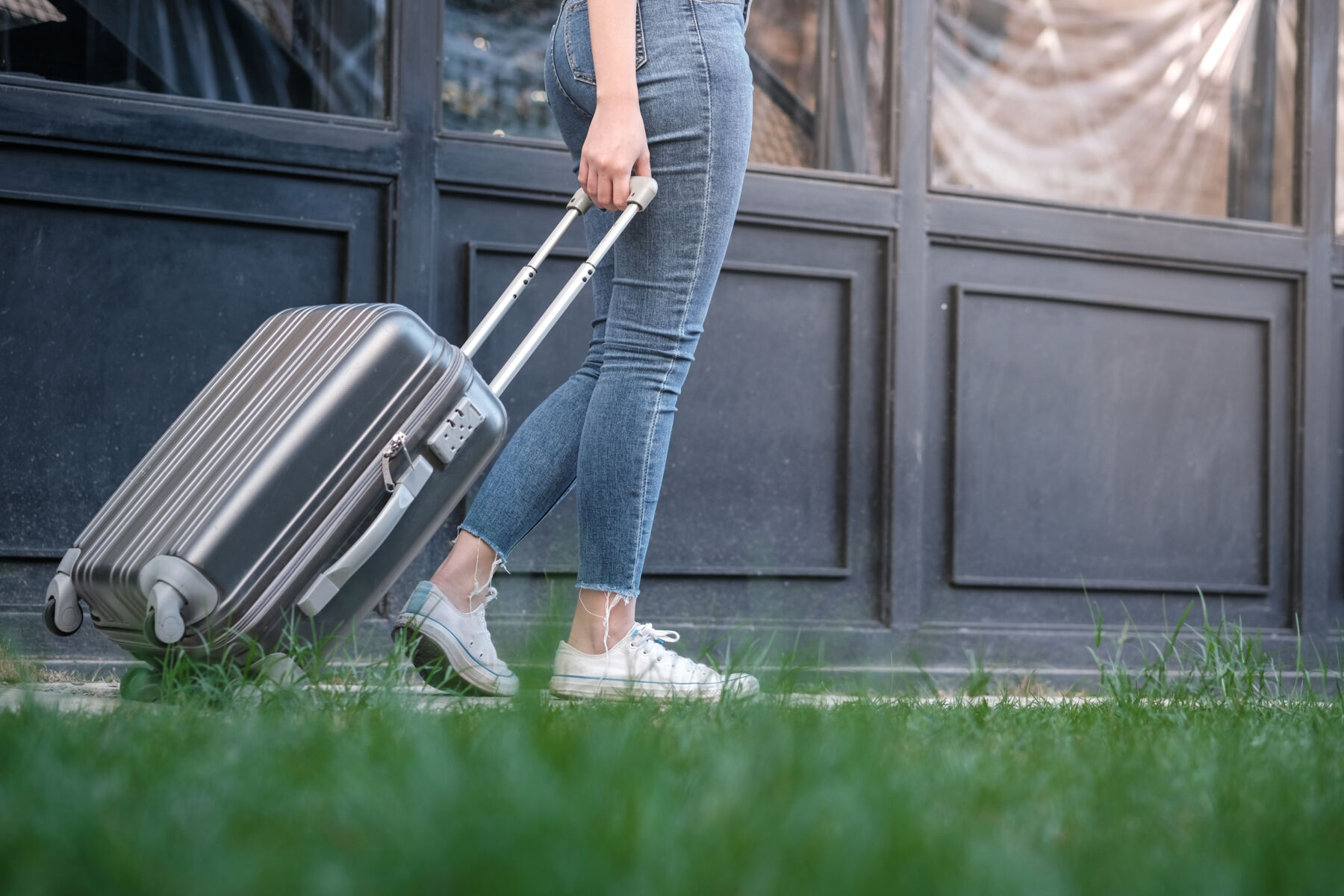 Photo shows traveler woman carrying luggage. Tourist walking with Suitcases Travel lifestyle concept