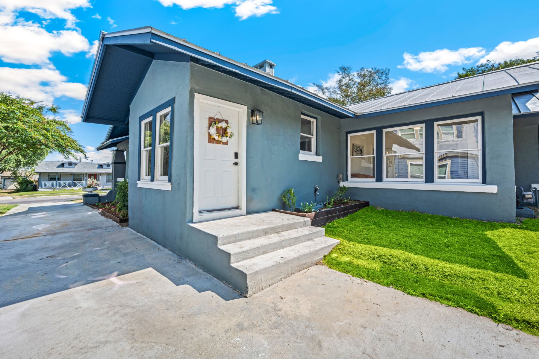 An exterior view of an older blue house.