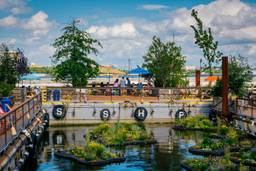 Photo shows Spruce Street Harbor Park, where floating gardens and vibrant seating create the perfect spot to relax by the water and soak in the summer vibes.