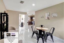 A dining room with a table and chairs.
