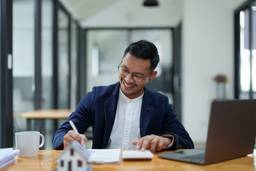 Photo shows Guarantee, mortgage, agreement, contract, sign, the customer is signing the contract document as evidence to the real estate agent or bank officer according to the agreement according to the document.