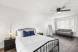 An image of a bedroom with a bed and couch.