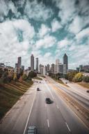 View of Atlanta, Georgia skyline with tall office buildings and apartments. A road leads you there.