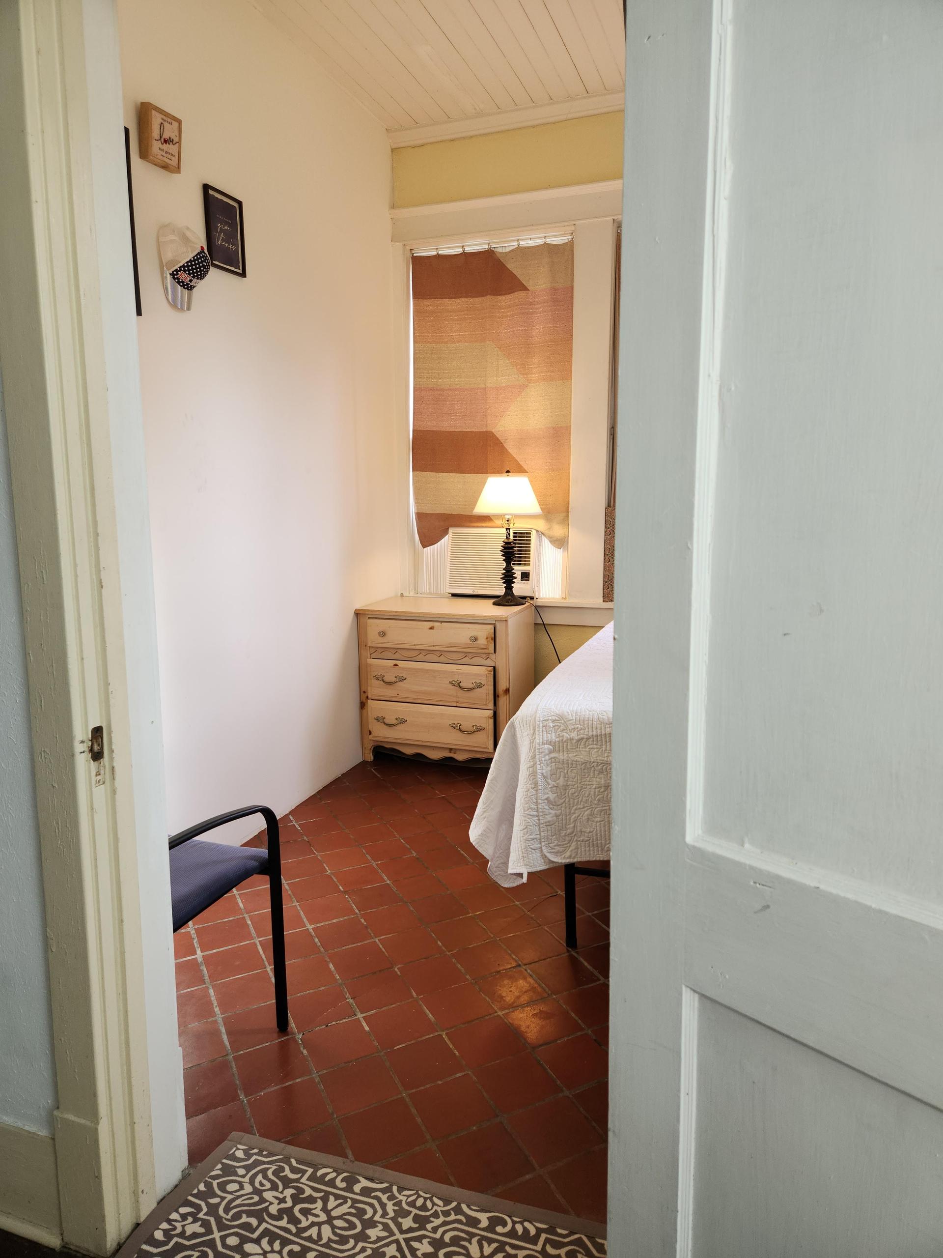 Cozy room. Front yard view with 4 windows. Twin bed, tile floor, window AC/Heat unit, work station and TV