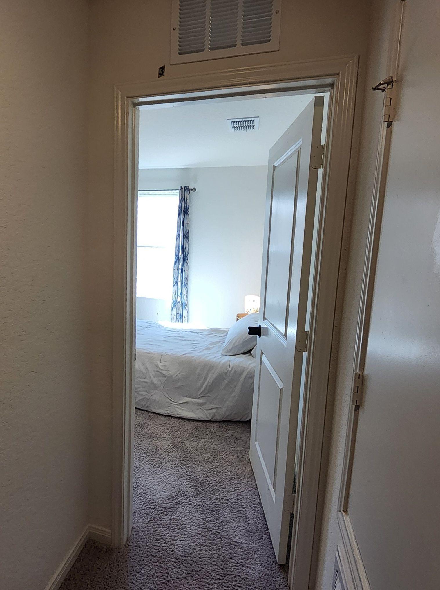 Your room has a comfortable bed and a pretty night stand.