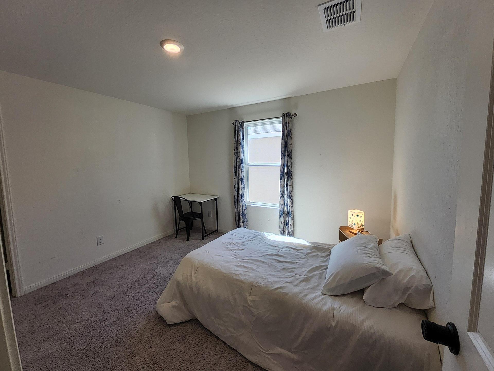 This room has a desk and drapes giving you space to get computer work done.