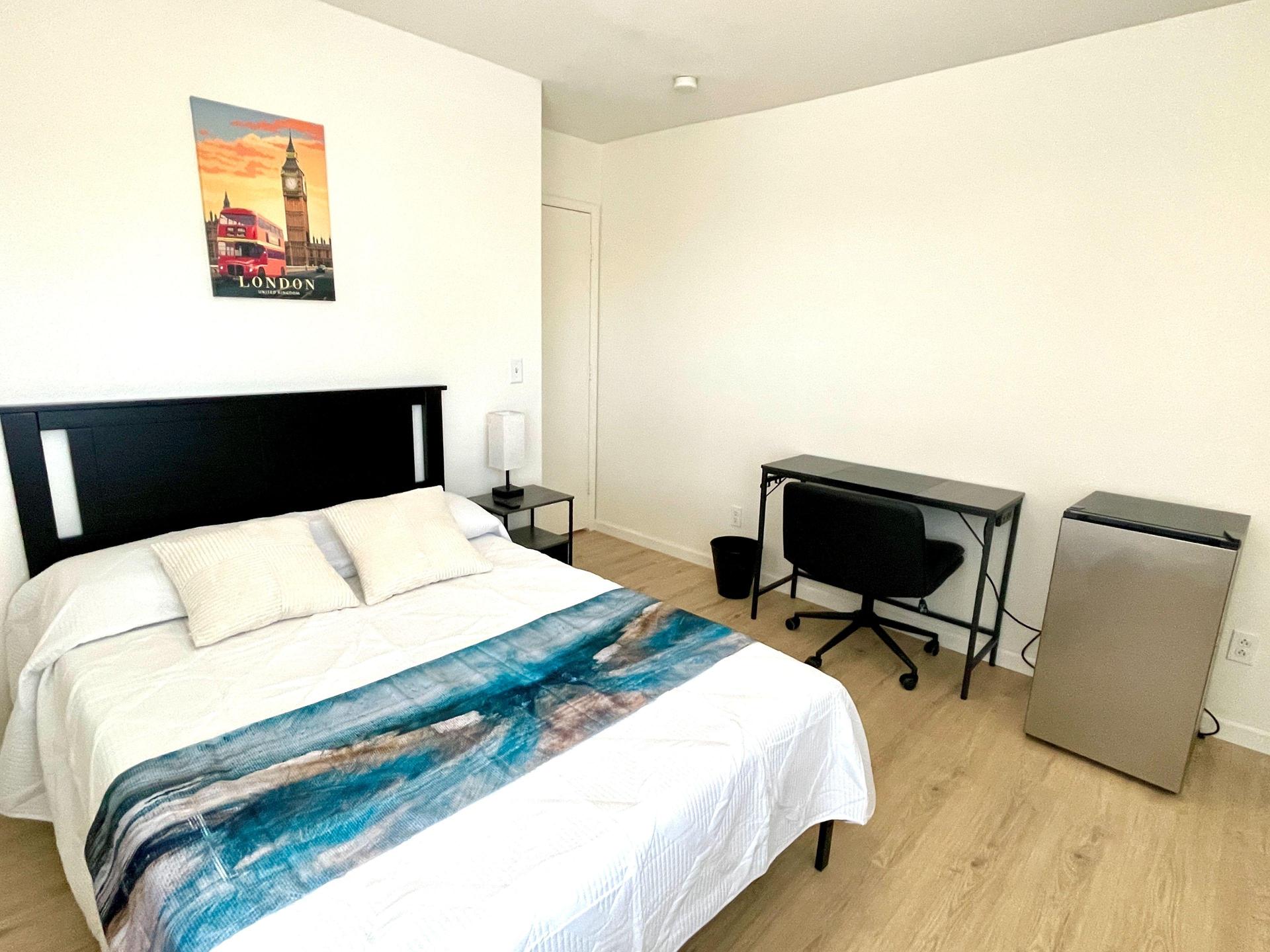 The London Room:   Large spacious bedroom with desk and a private mini-fridge