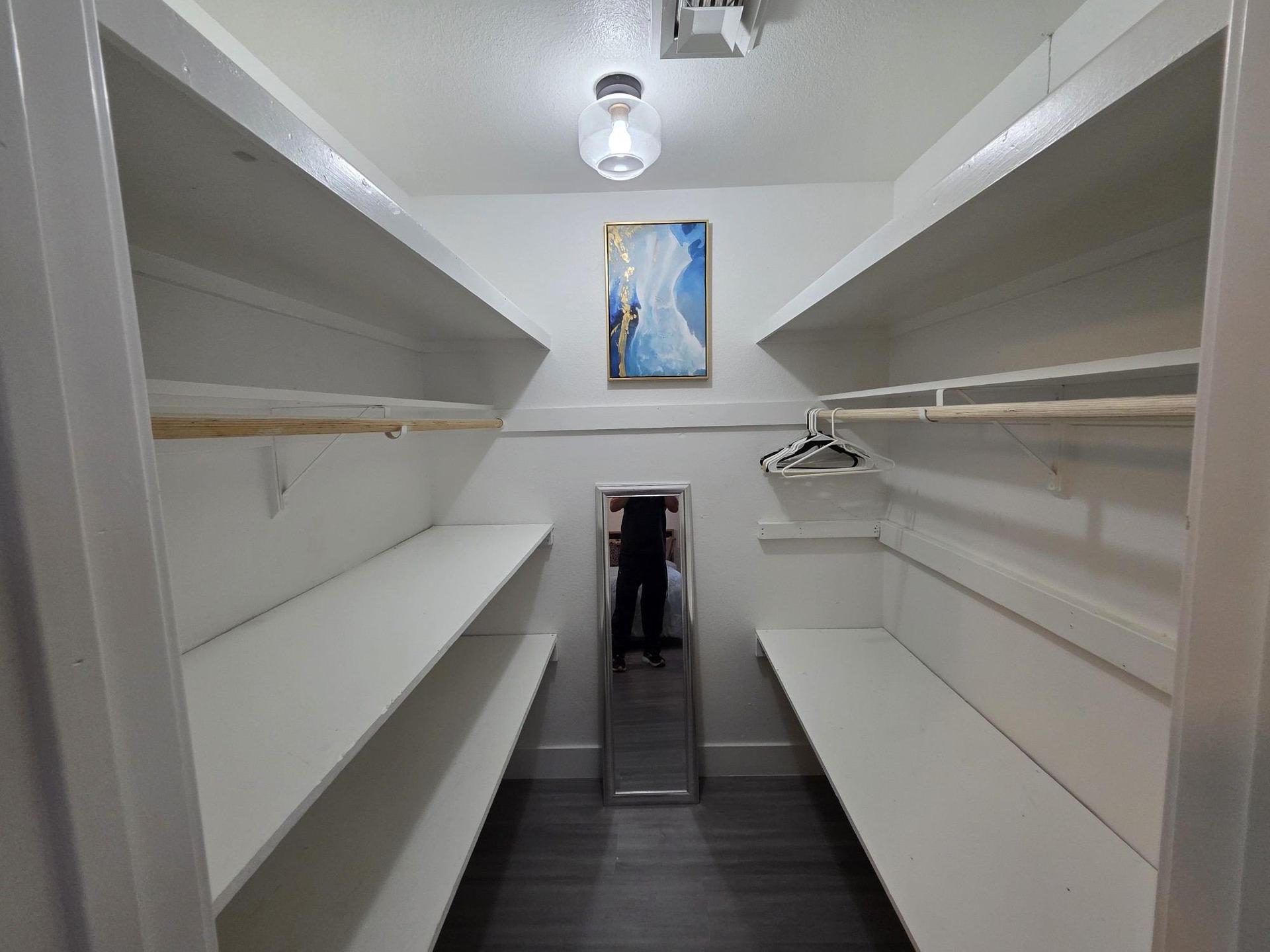 walk in closet with mirror