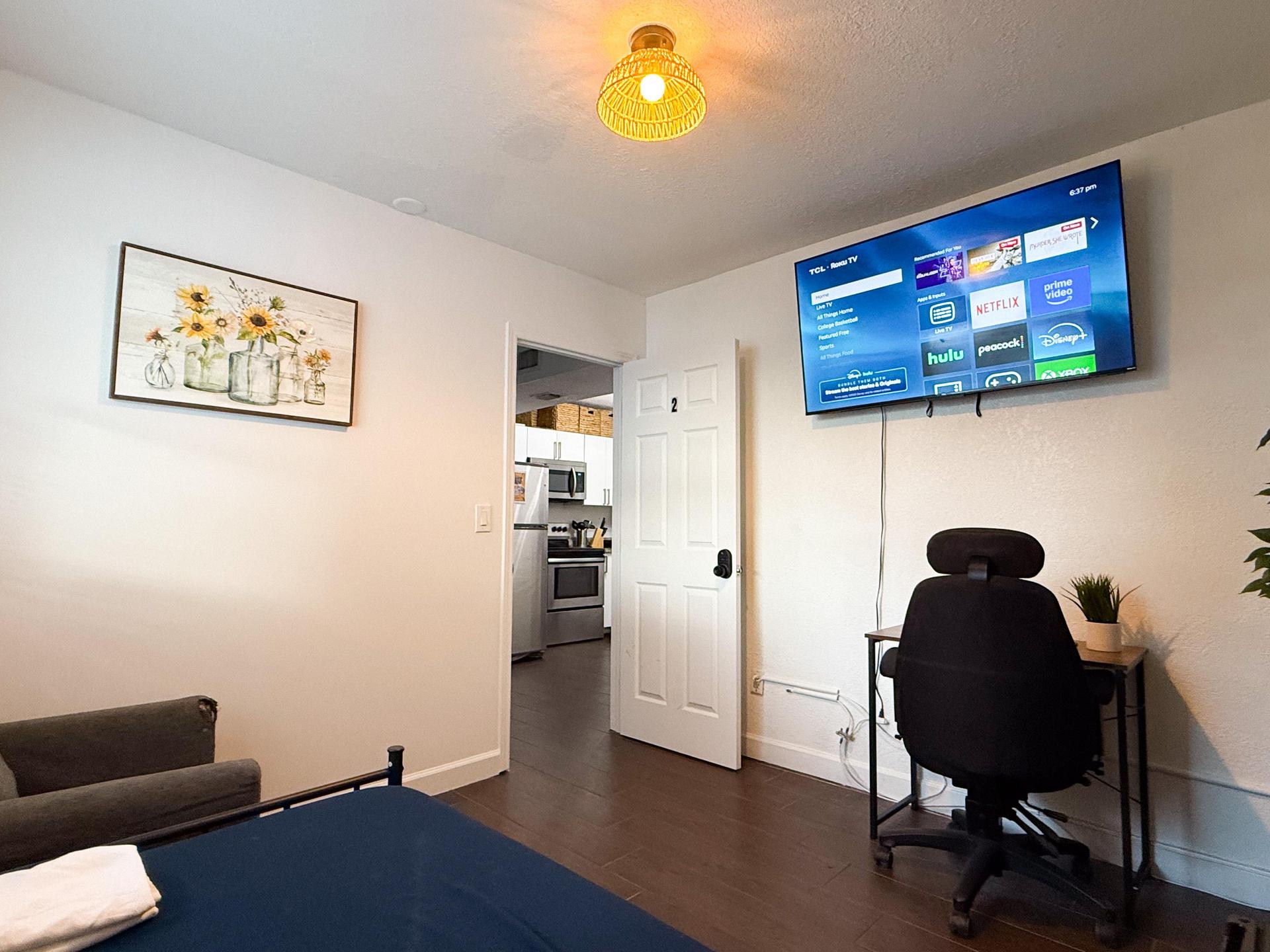 Single bed with mini fridge and 4K Smart TV