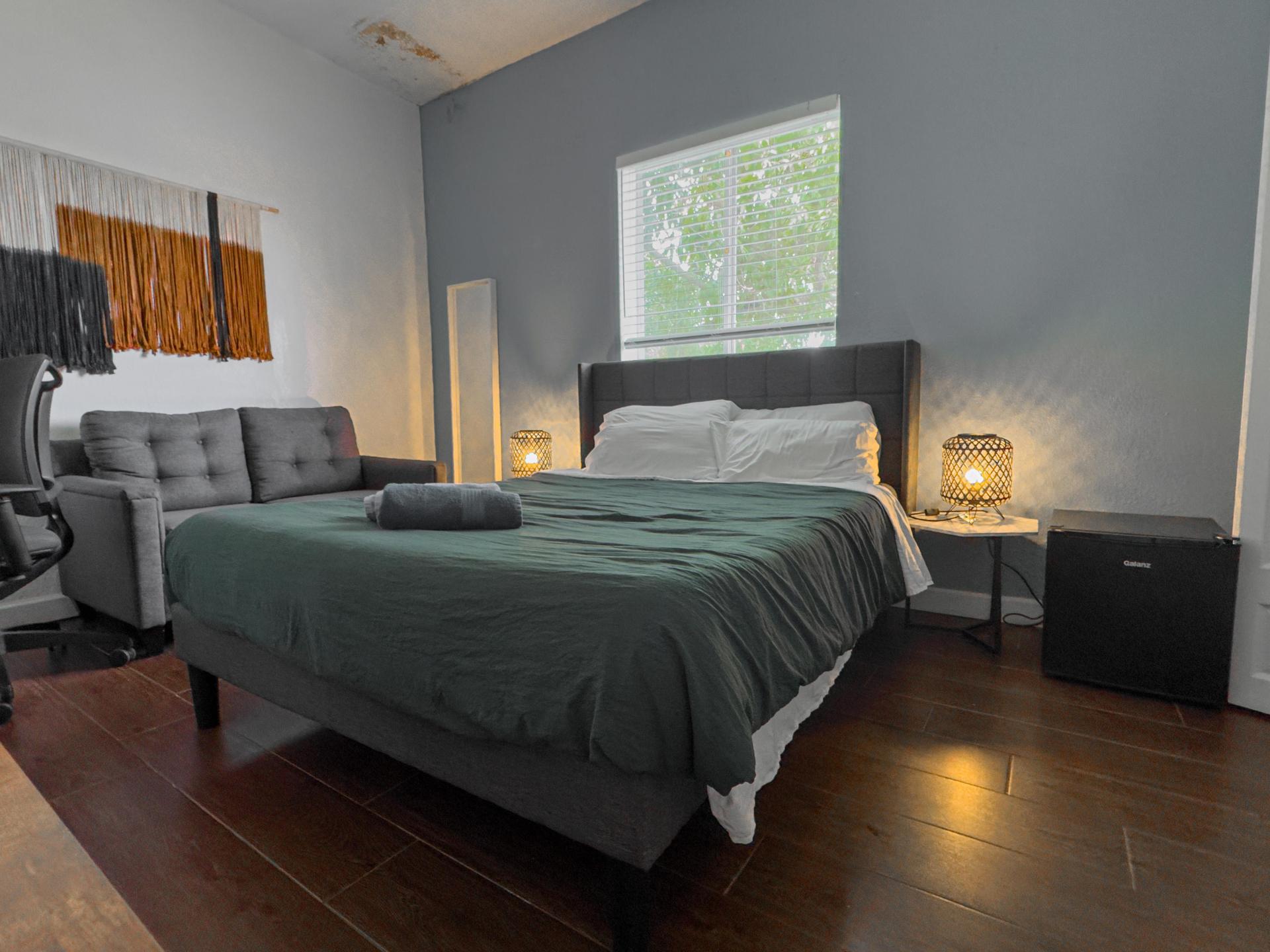 Queen bed with mini fridge and 4K Smart TV