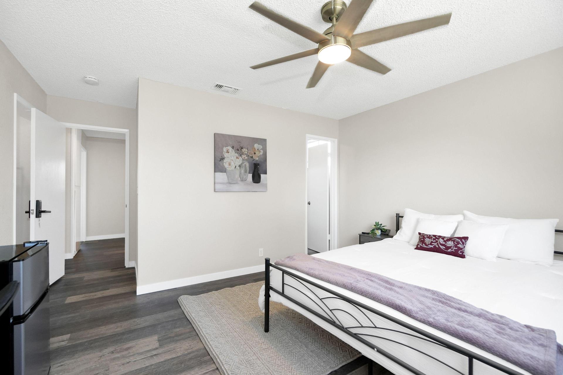 Quiet bedroom with ceiling fan and door lock