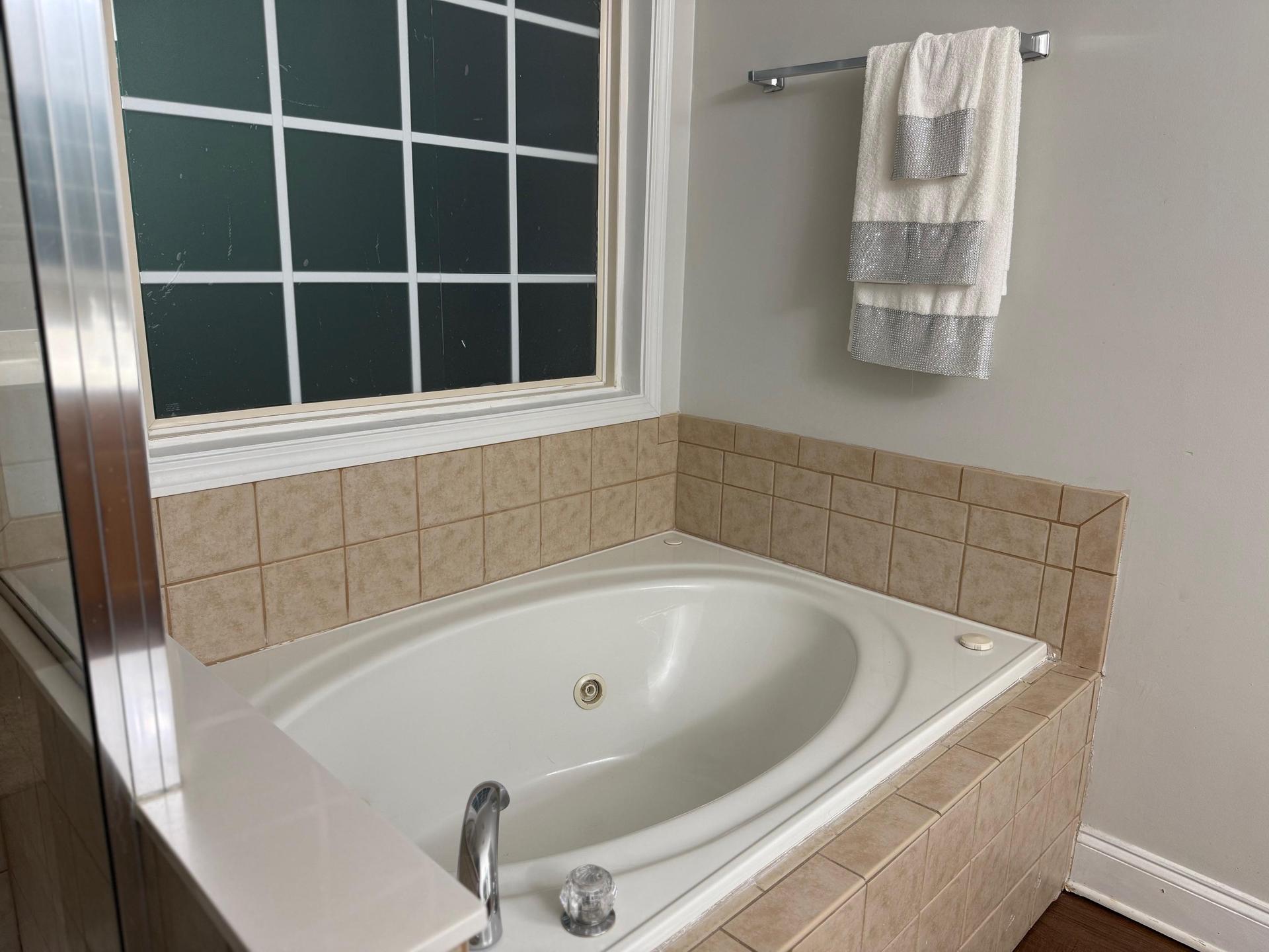 Spa vibes at home:  Jacuzzi tub, and a separate walk-in shower.