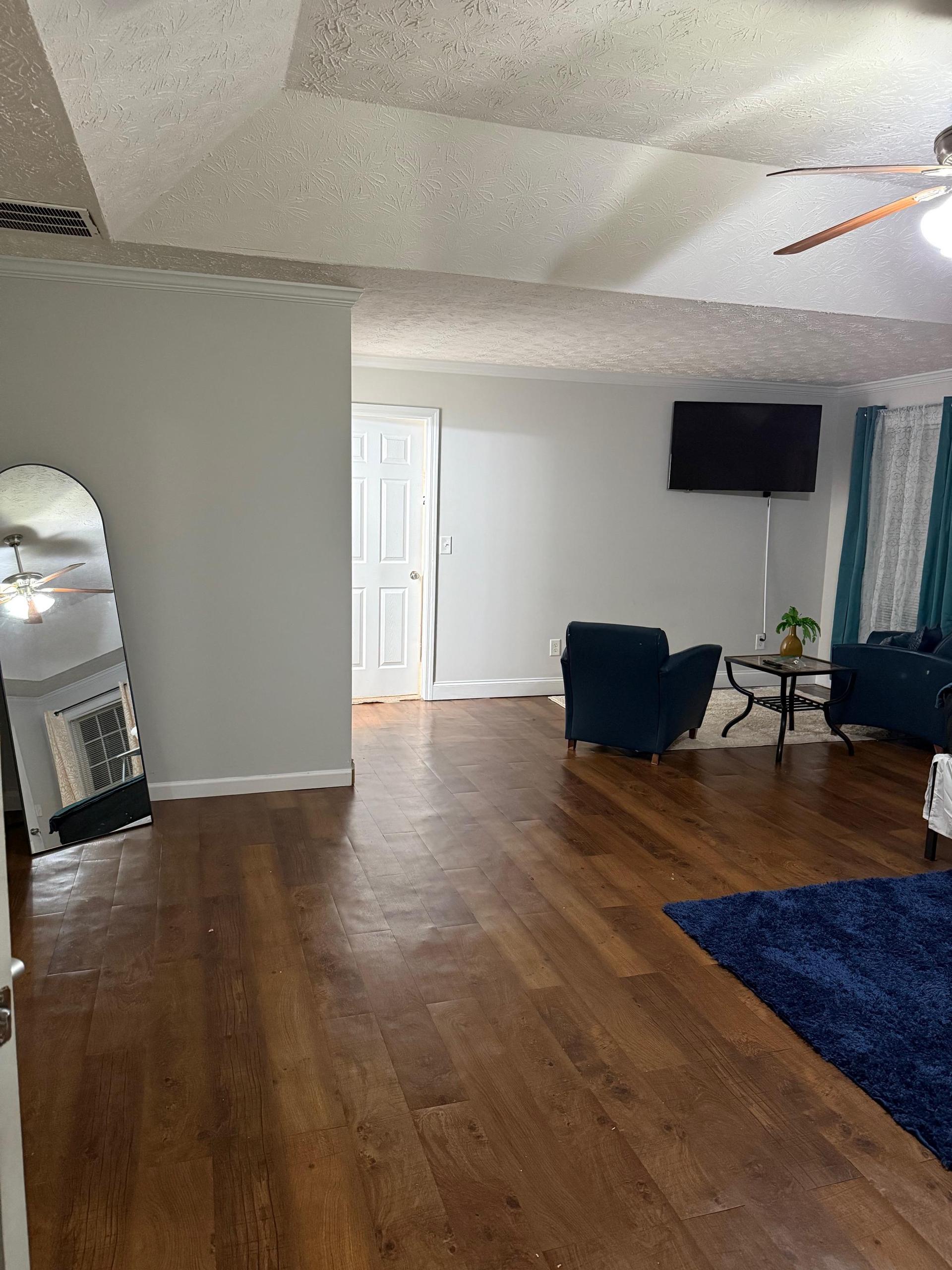 Your personal sanctuary—master suite featuring a cozy lounge space and dual oversized walk-in closets.
