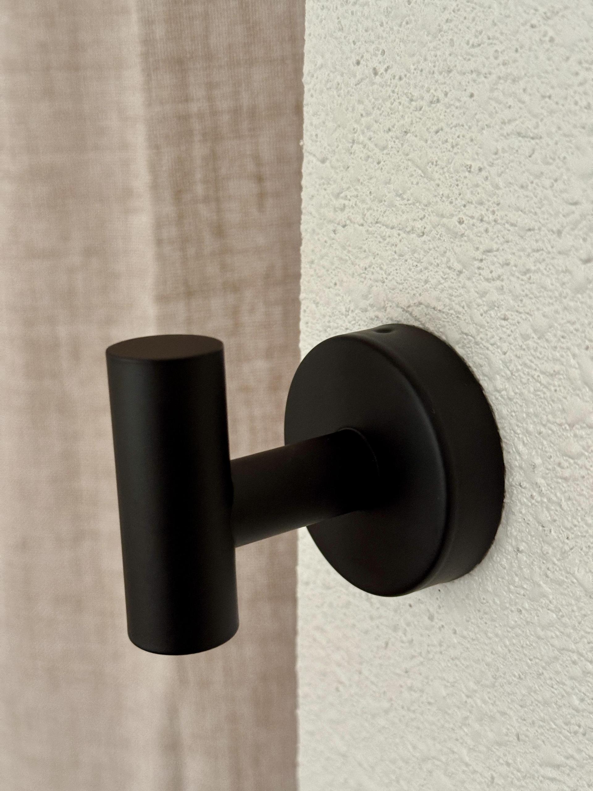 Towel Hook on the wall near closet.
