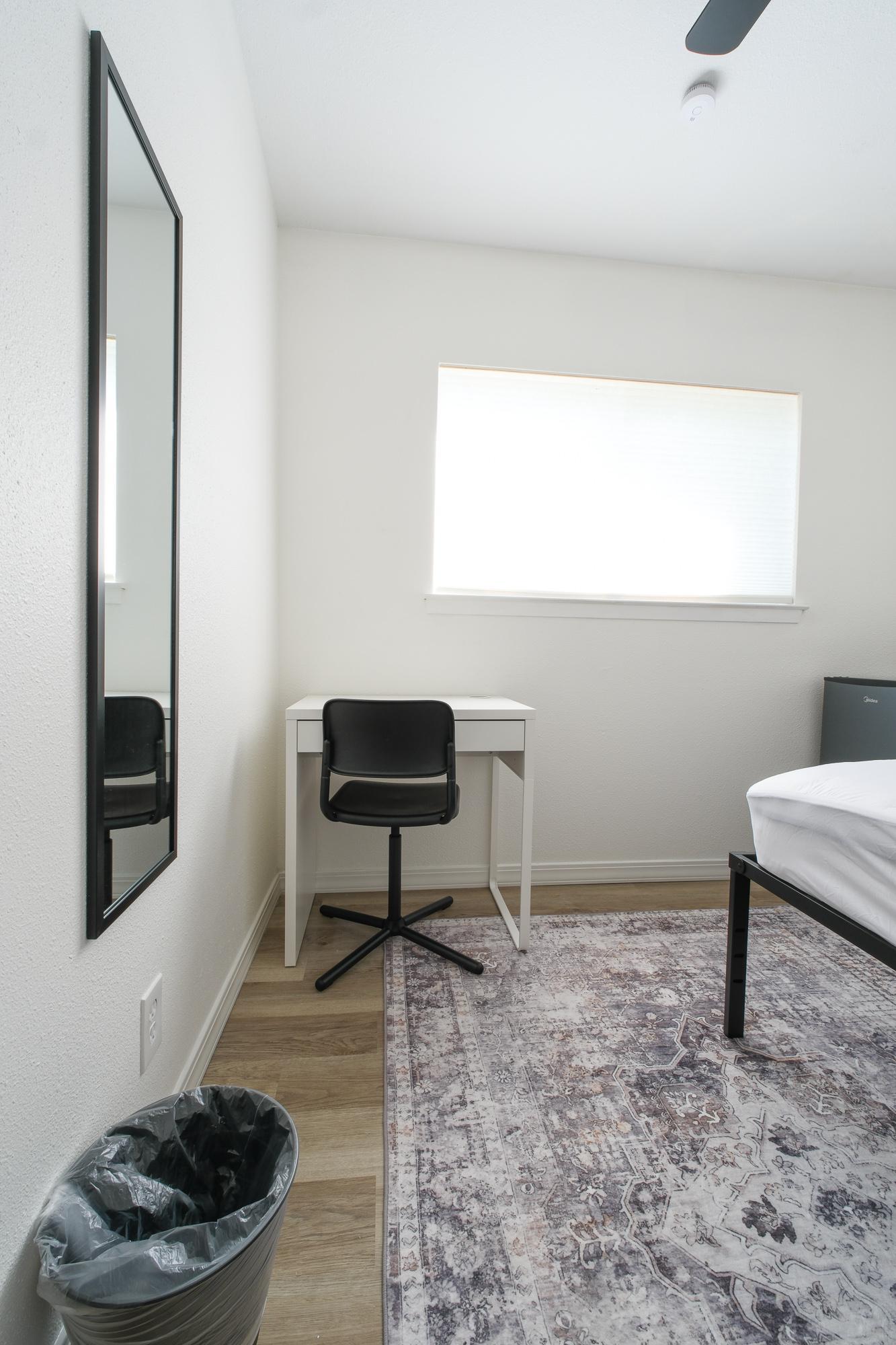 Fridge, Tall Bed, Side Table, Desk & Chair, Overhead Fan, Floor Rug, Mirror