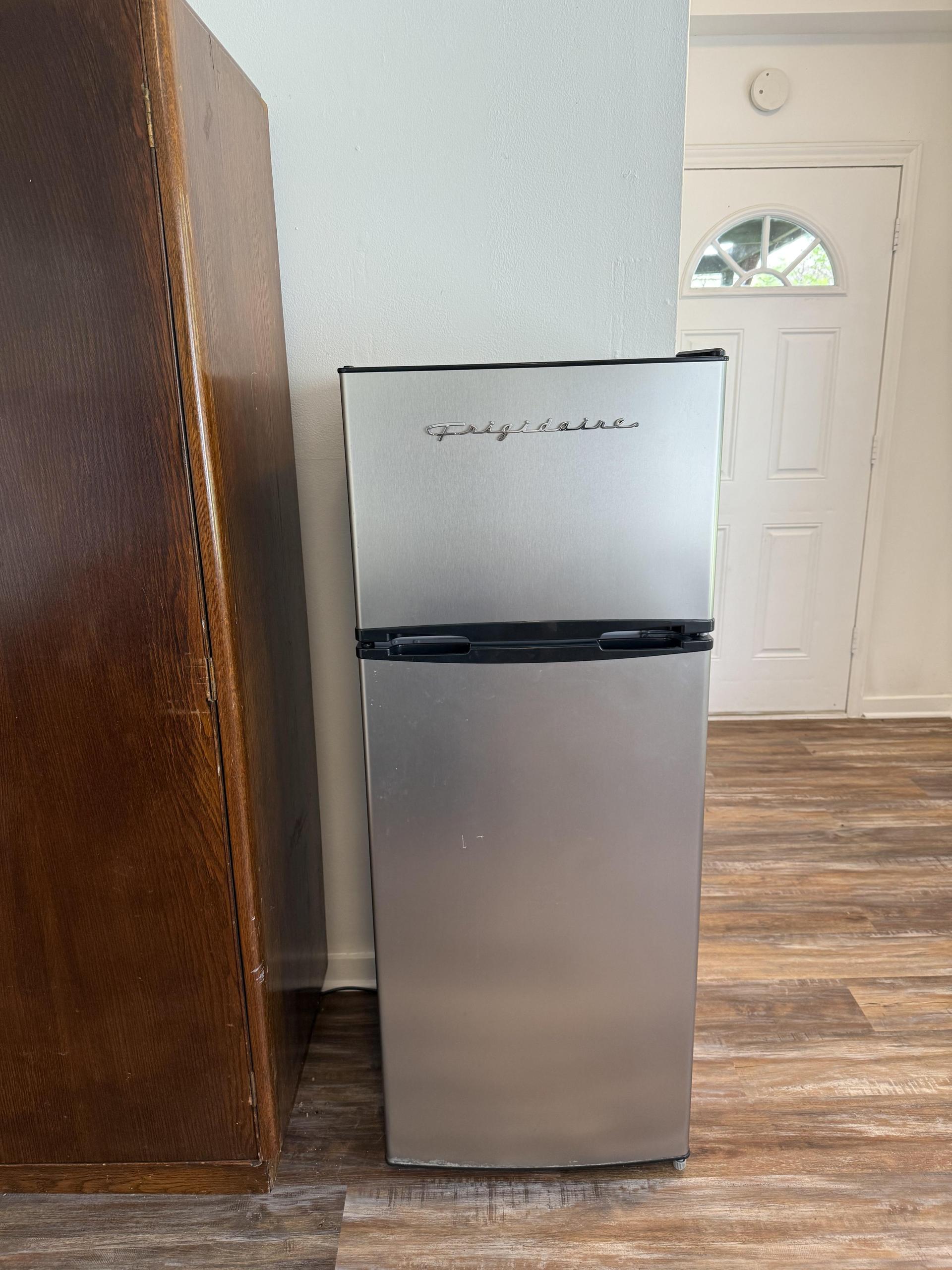 Apartment size fridge in room