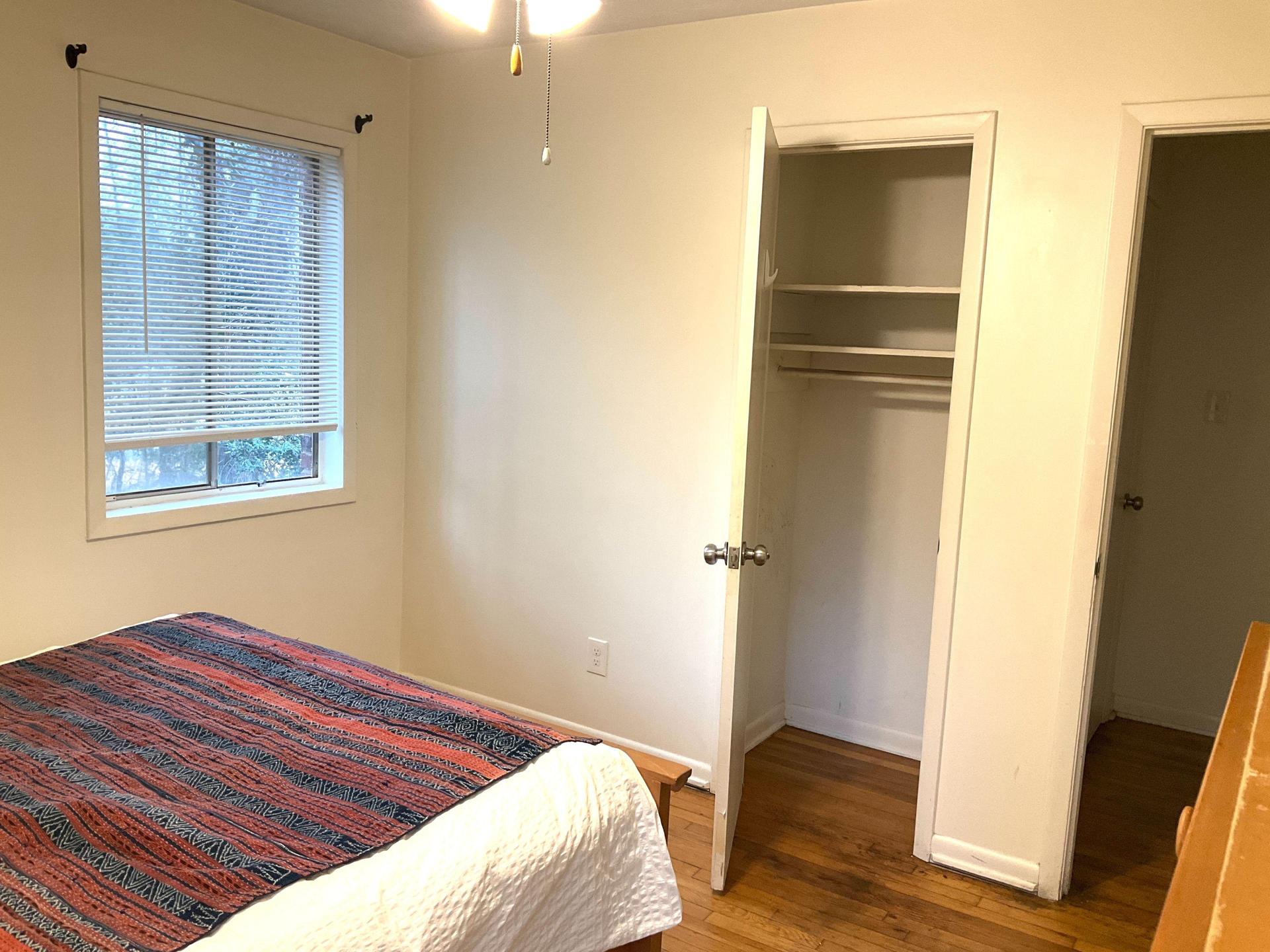 This corner room has two windows, a dresser and a built-in closet.