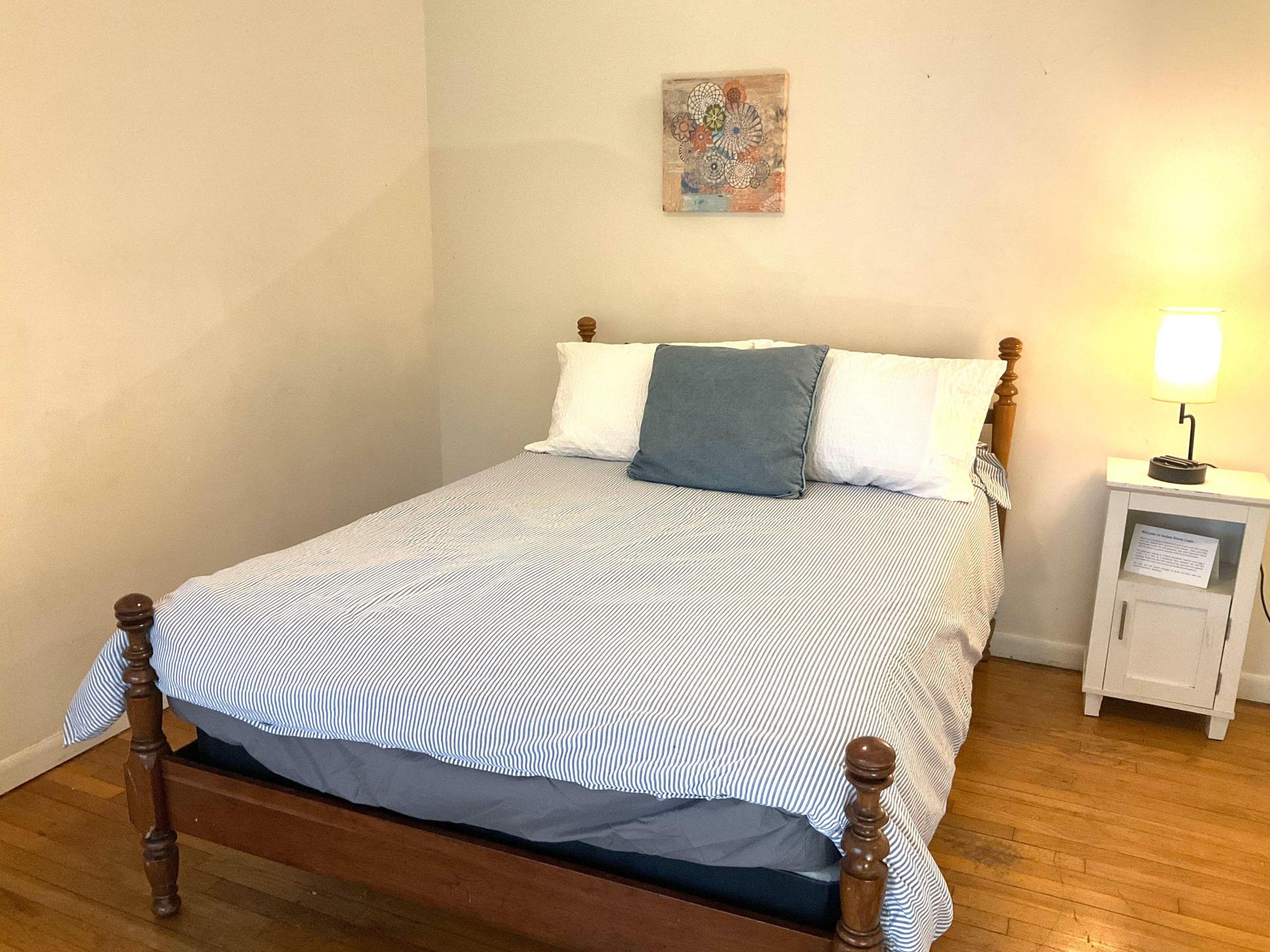 Full-size bed with nightstand & lamp