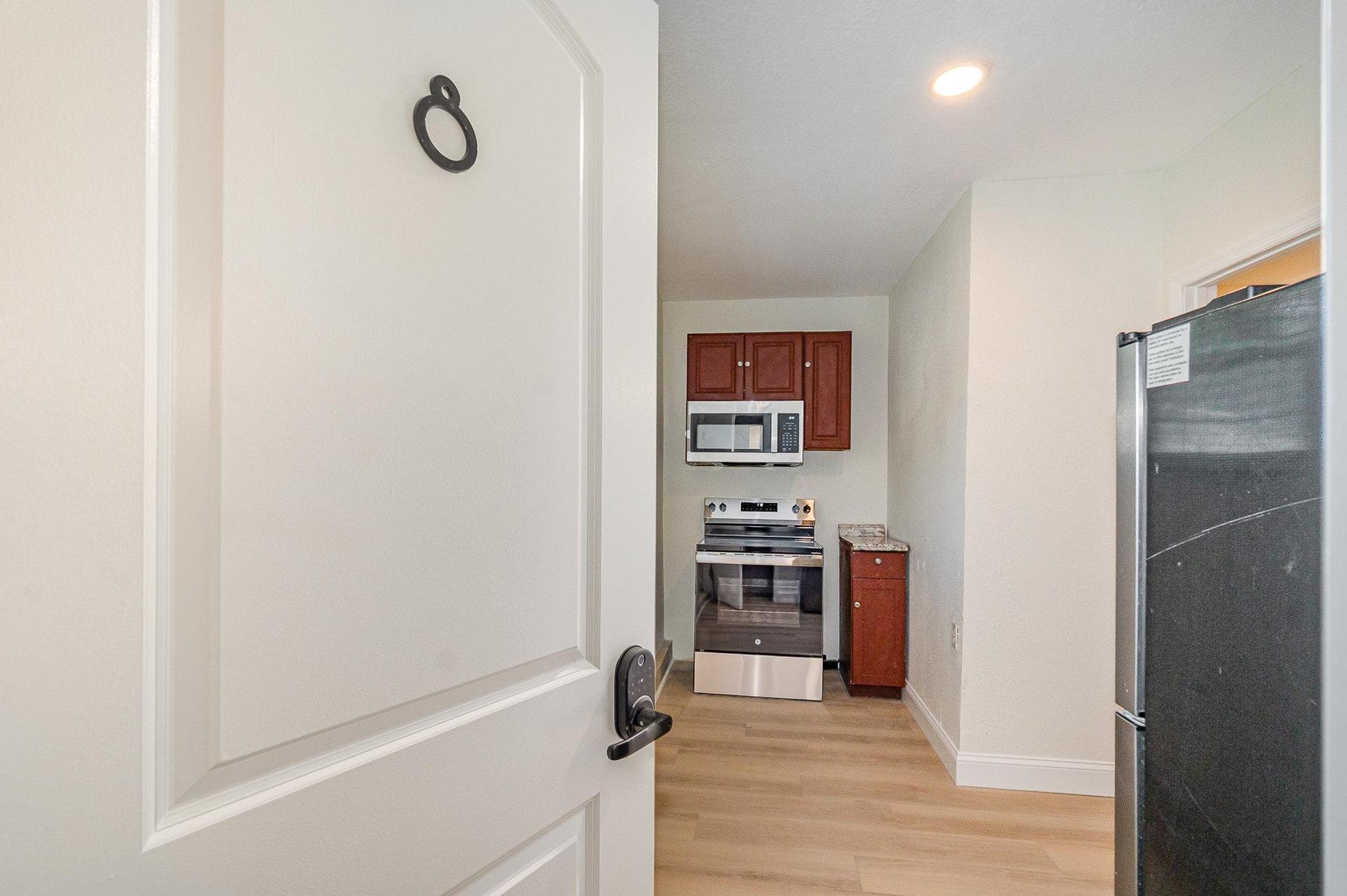 Room 8's full size stove, microwave, and ref
