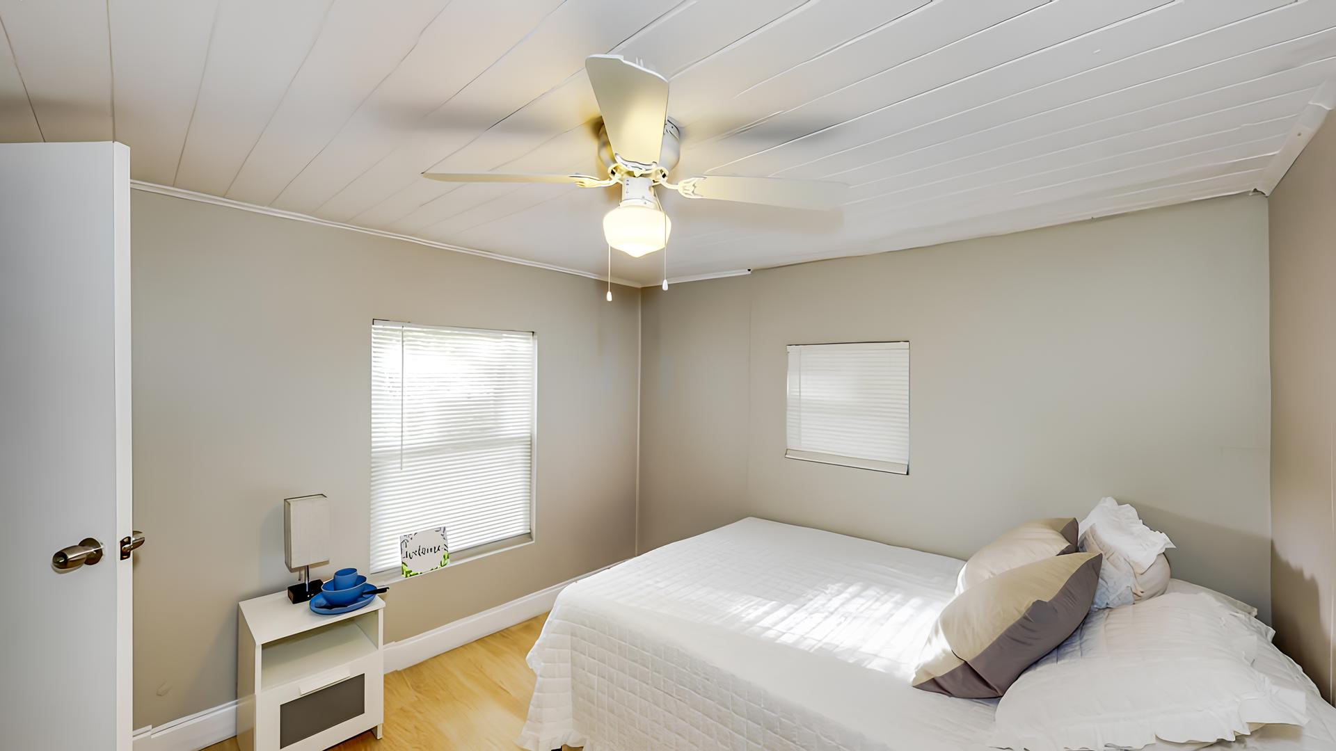 bedroom, detected: window blind, bed, ceiling fan
