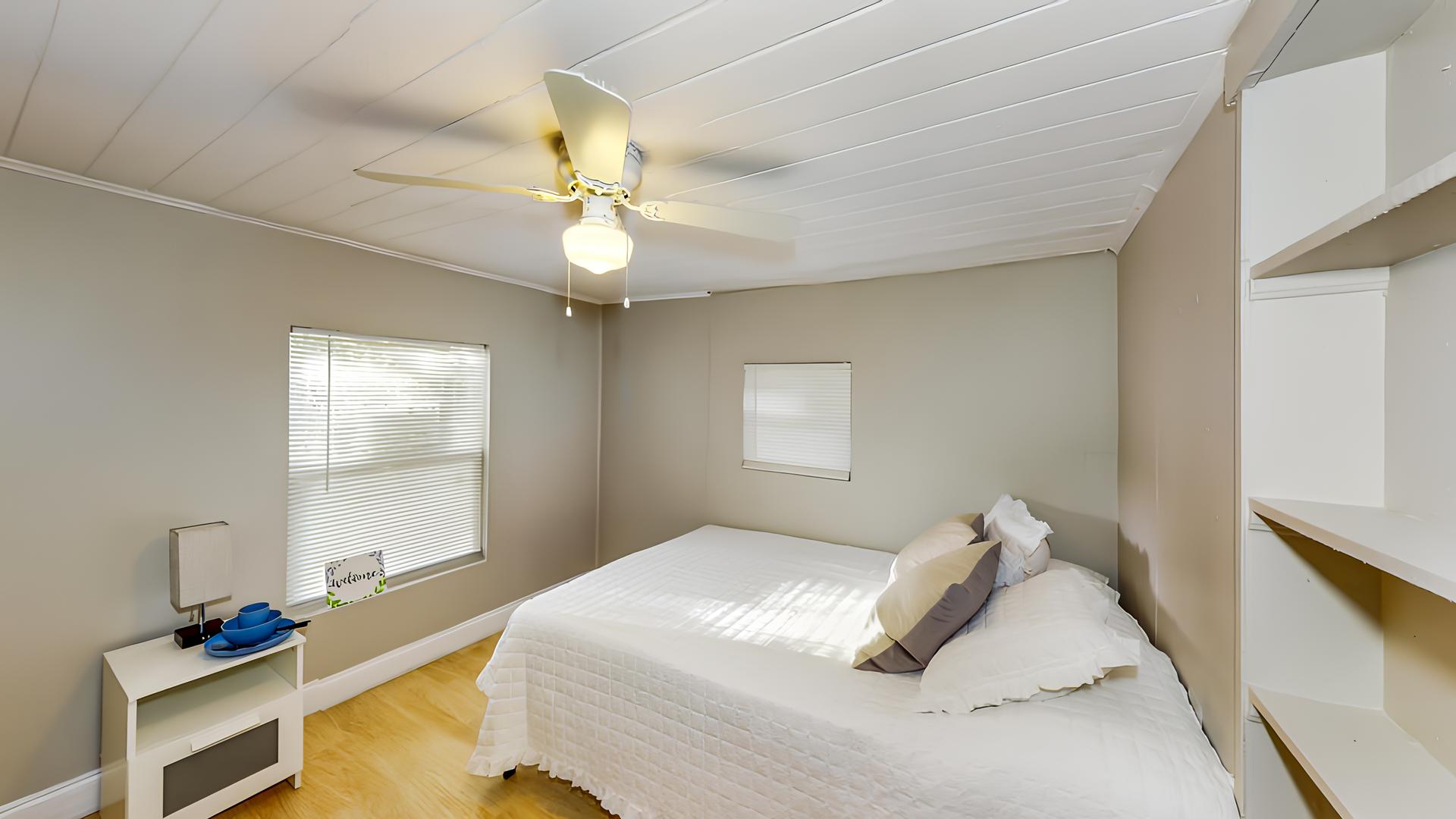 bedroom, detected: window blind, bed, ceiling fan