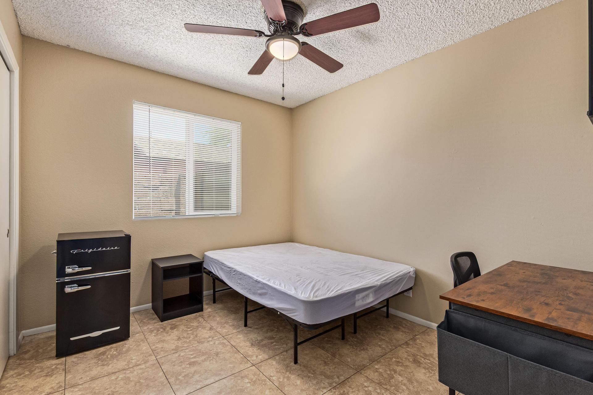 Full size bed, workspace/desk and office chair, mini fridge/freezer