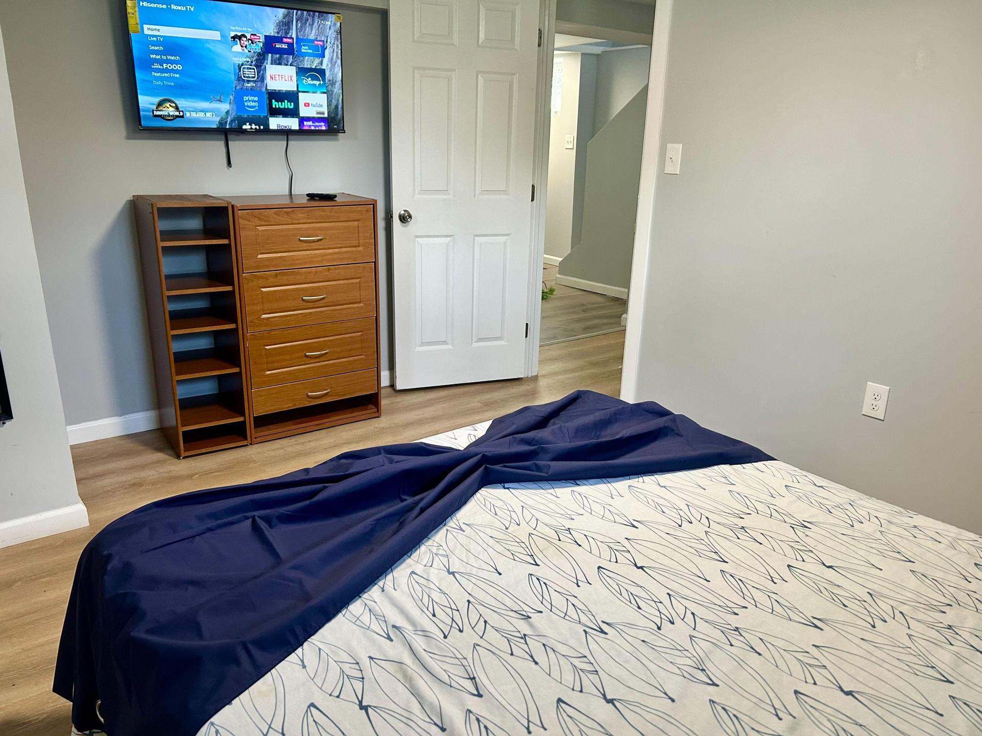 Queen bed with smart tv, basement room