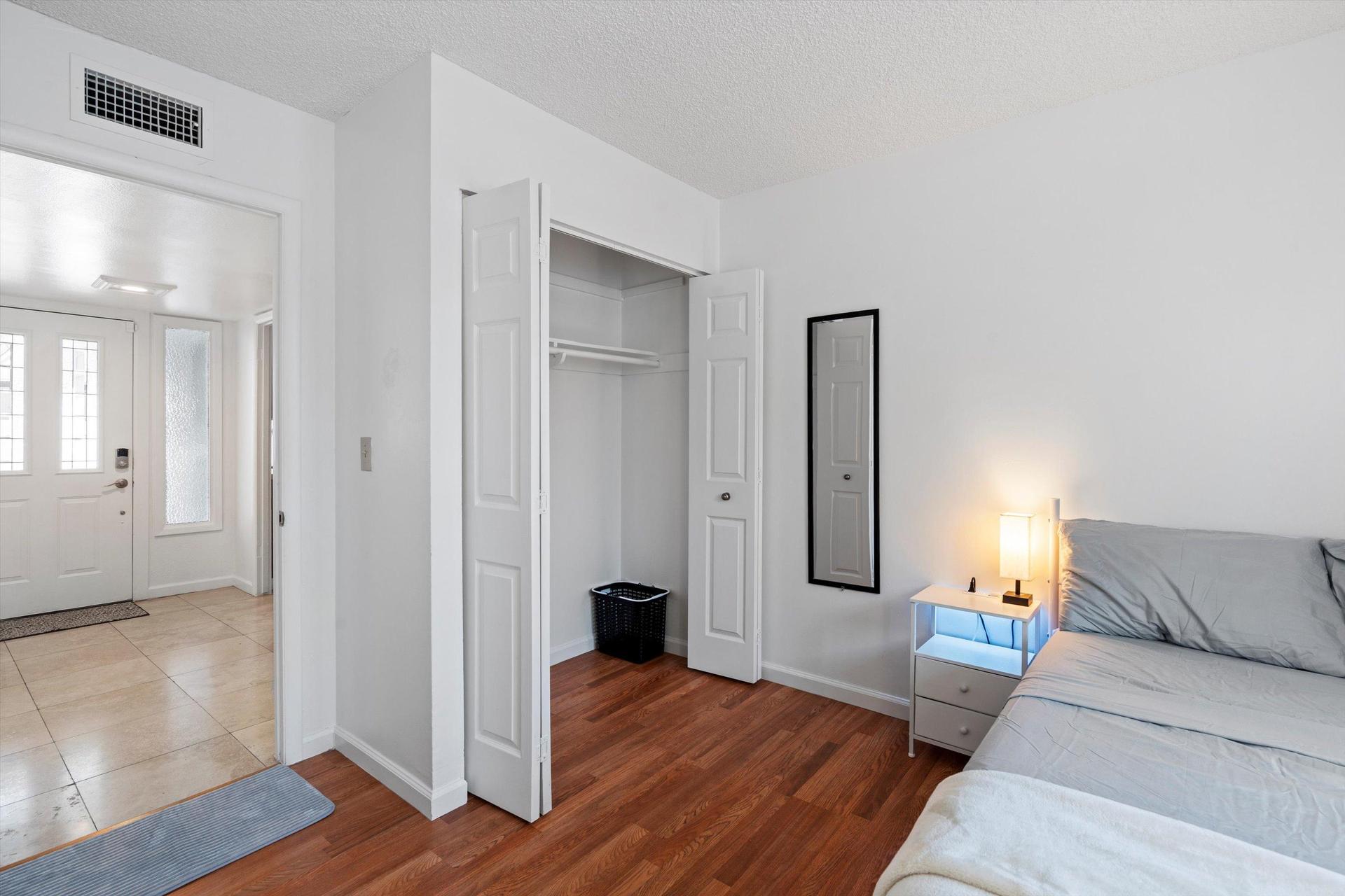 Spacious closet with mirror and laundry basket equipped