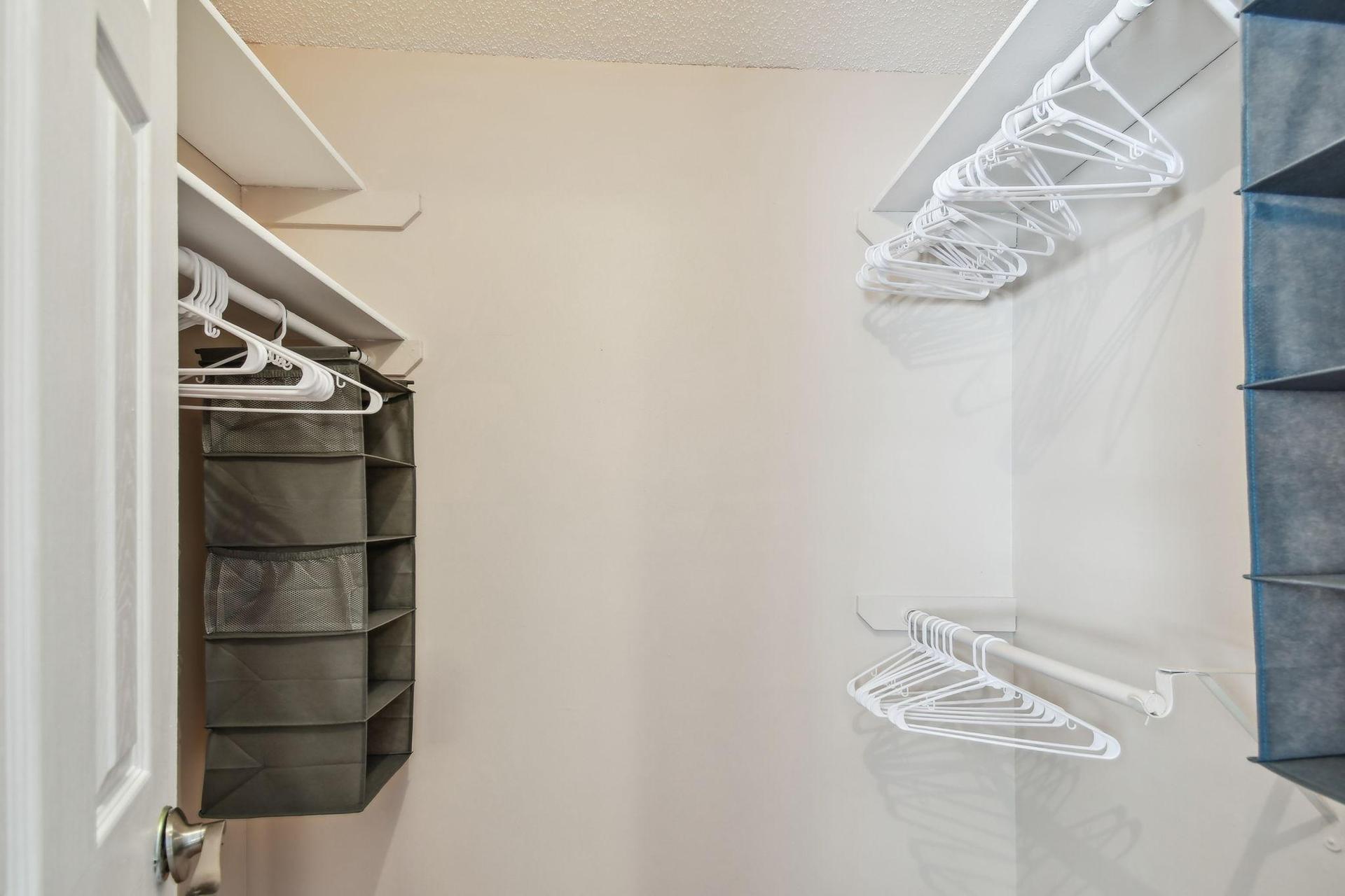 Oversized walk in closet with plenty of storage