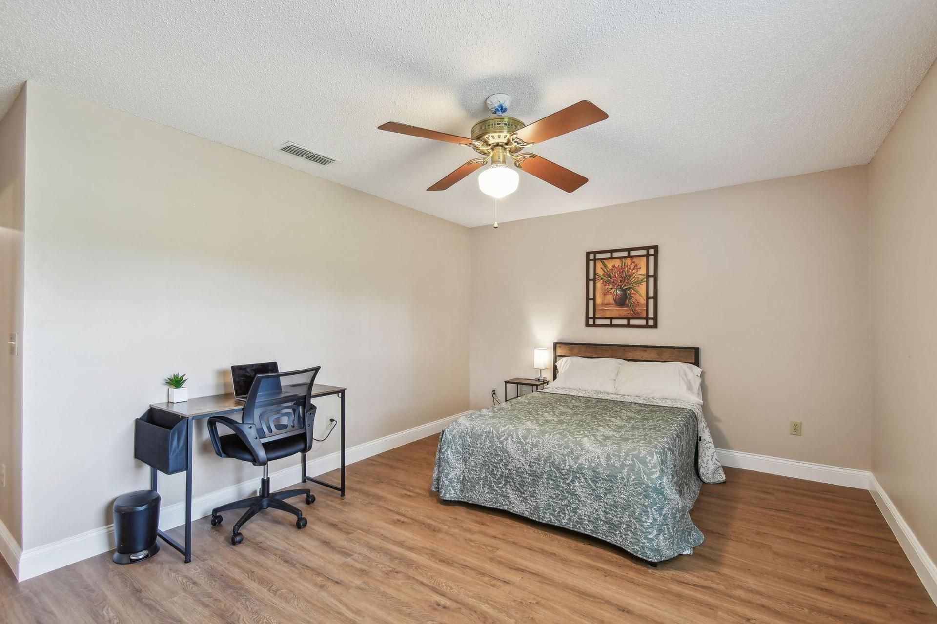 Full size cozy full size bed, with end table, light, desk, office chair and light, storage container under the bed and closet