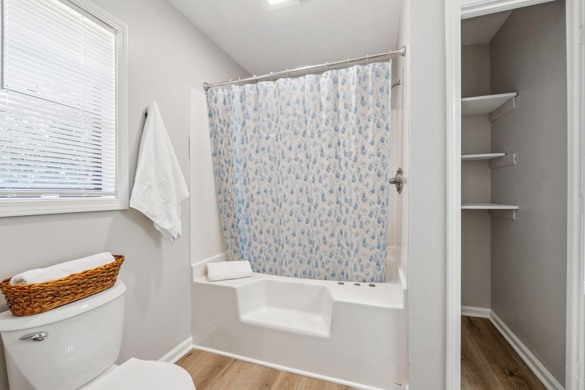 Private bath with large soaking tub and extra storage.