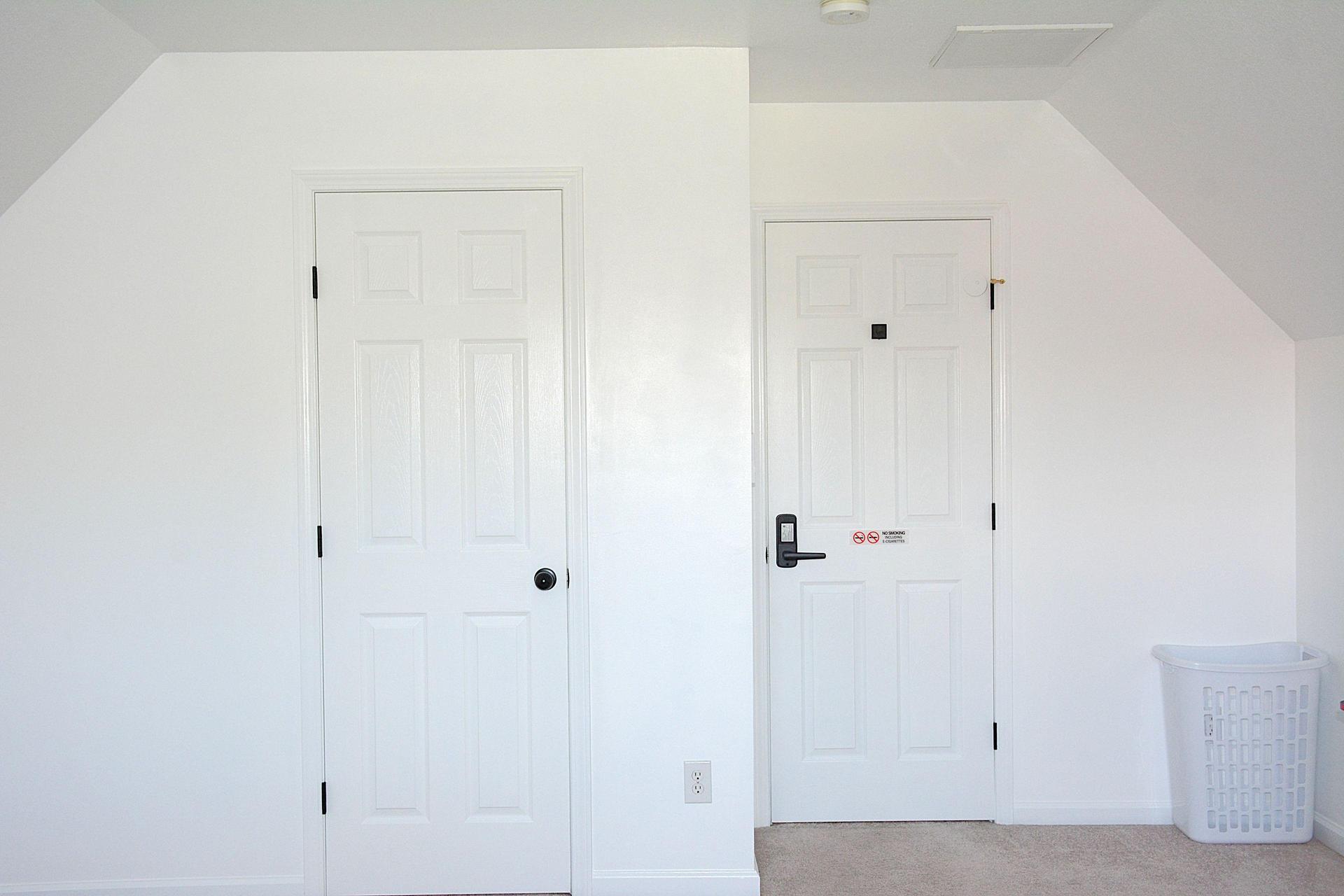 View from the bed to the entry door, supplied is a hamper for your convenience.