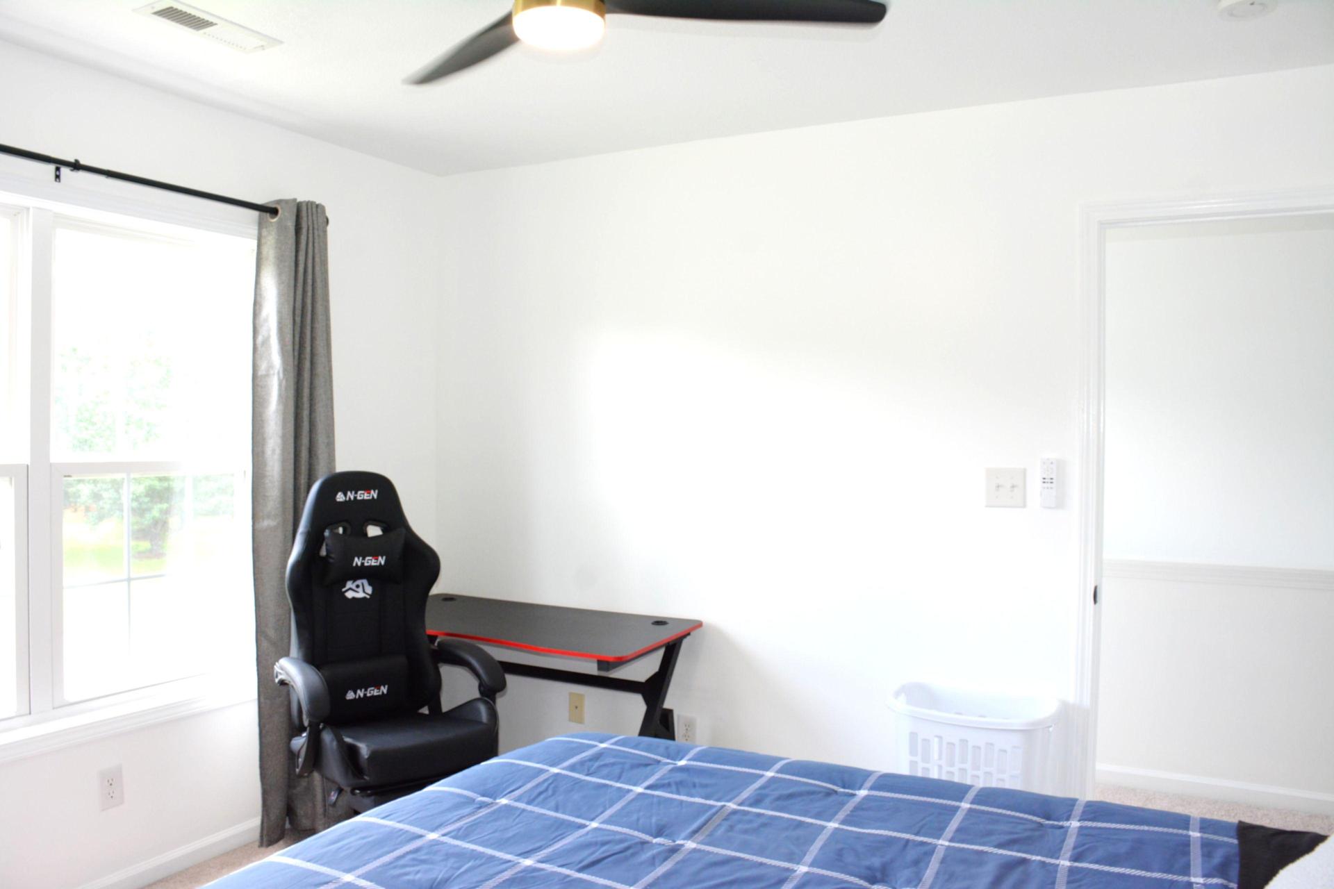 Desk and chair with a room hamper.