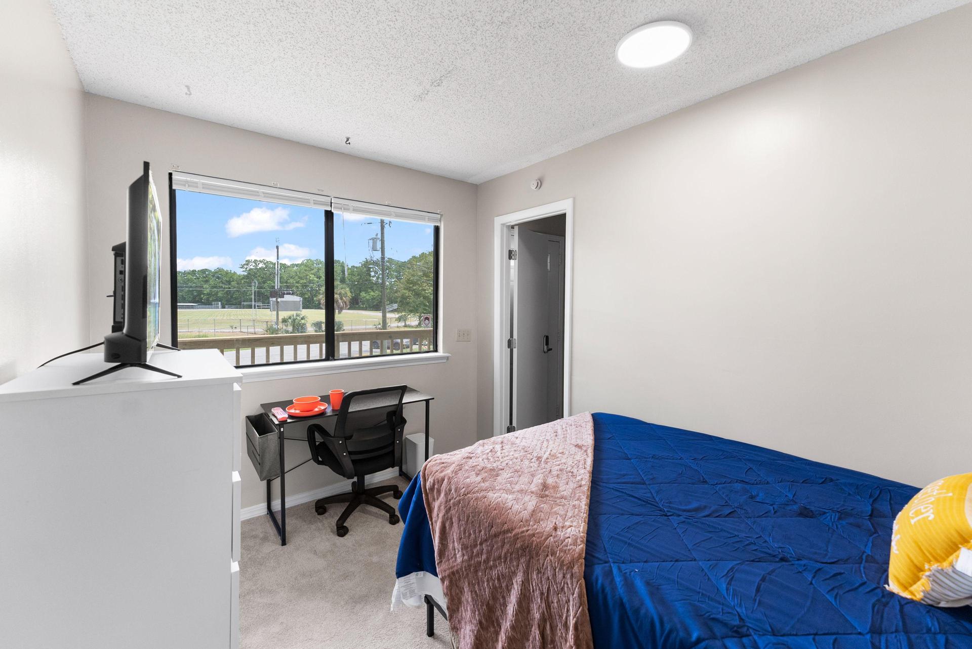 Bright and sunny bedroom with shared bathroom