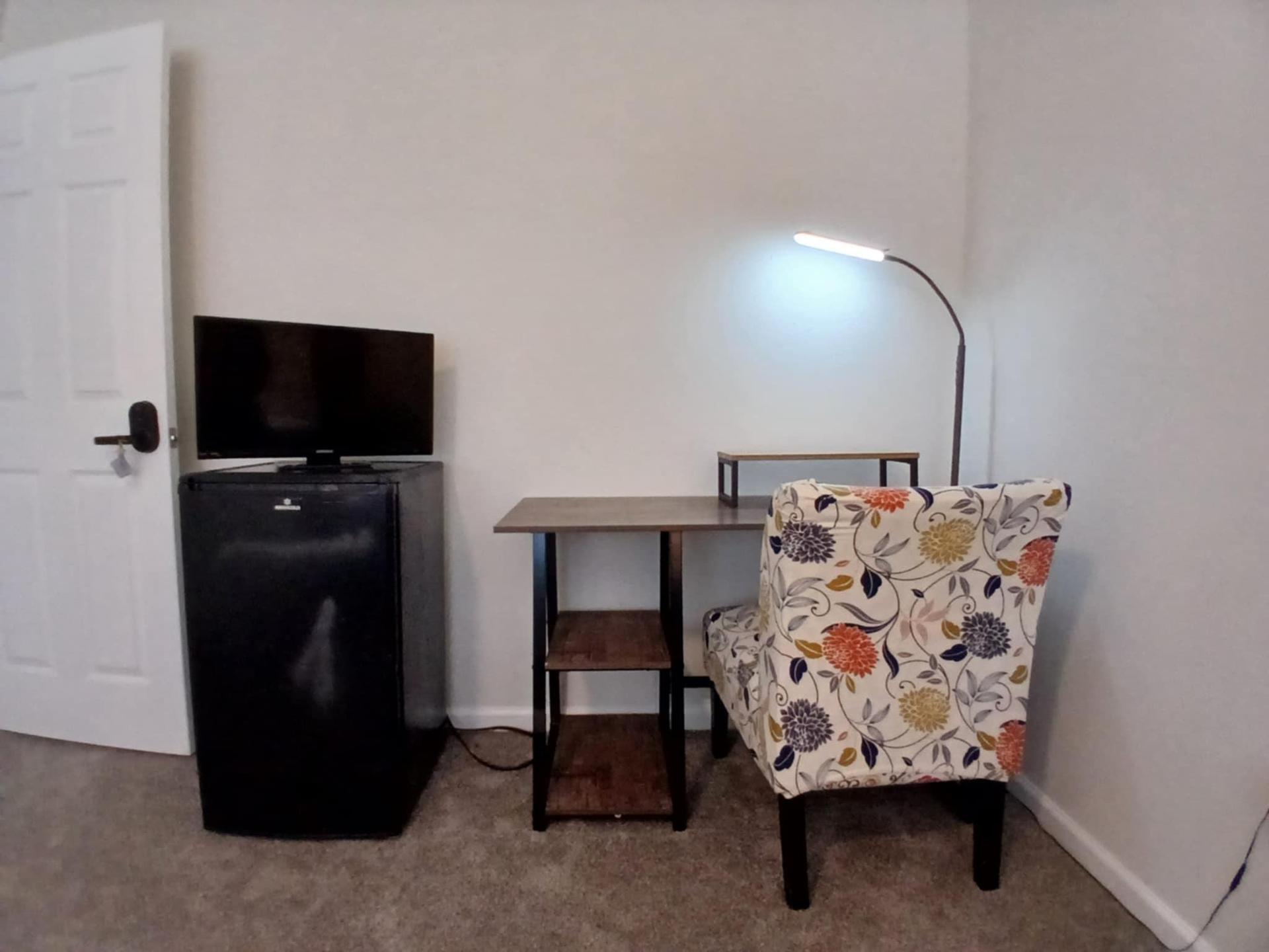 Workstation, mini-fridge and television