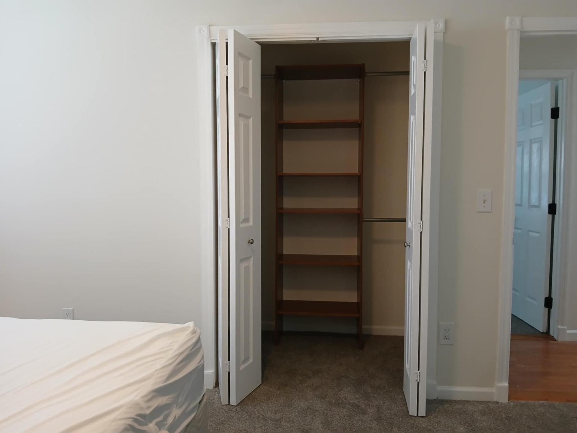 Reach in closet with built-in shelves.