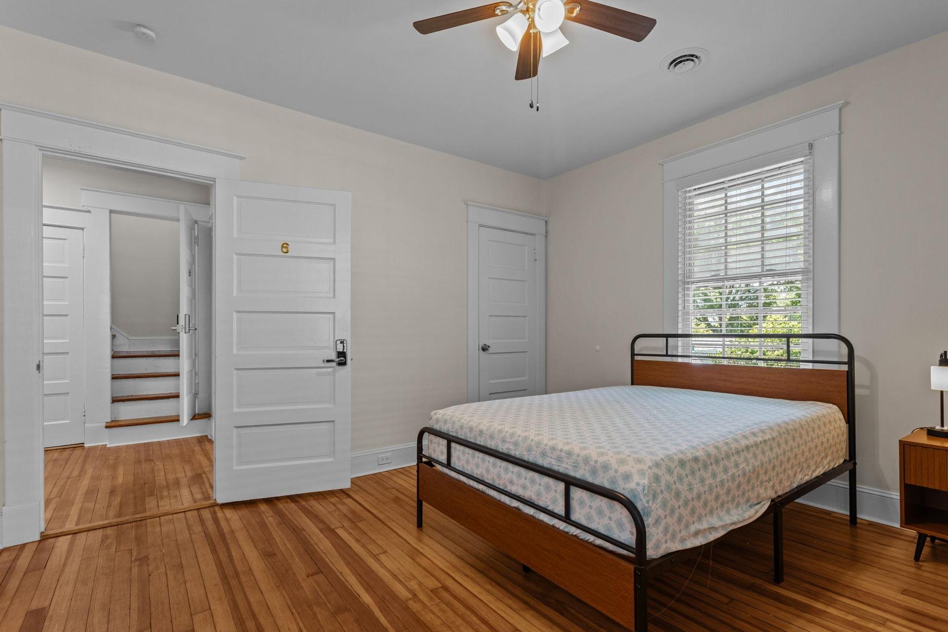 Room includes hardwood floors, ceiling fan, and built-in closet.