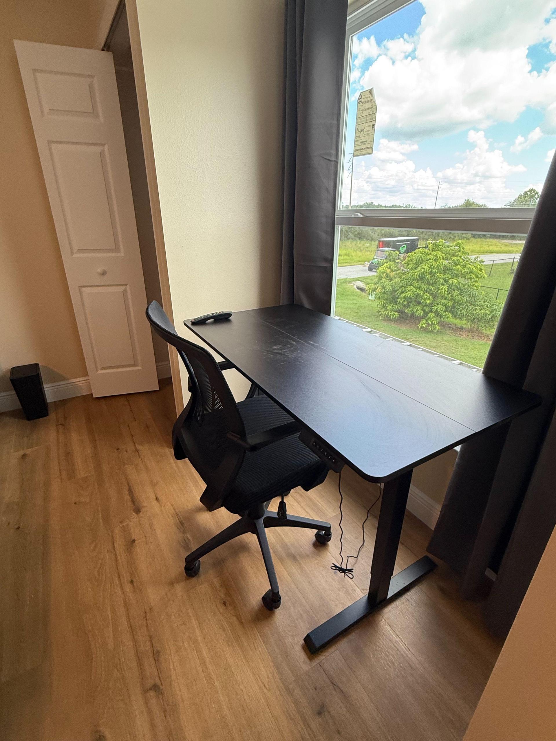 electric standing desk, ergonomic chair & garbage