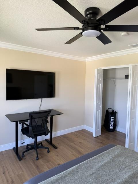 electric standing desk, ergonomic chair and 55" smart TV & closet w/ portable laundry bag