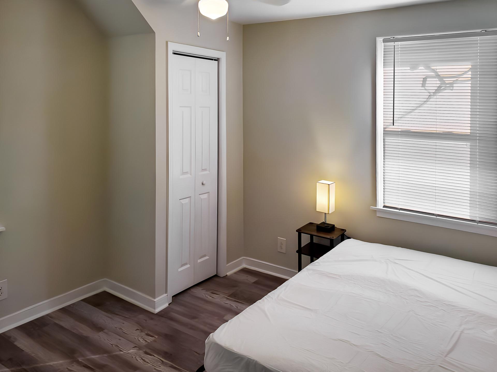 bedroom, detected: window blind, bed, ceiling fan