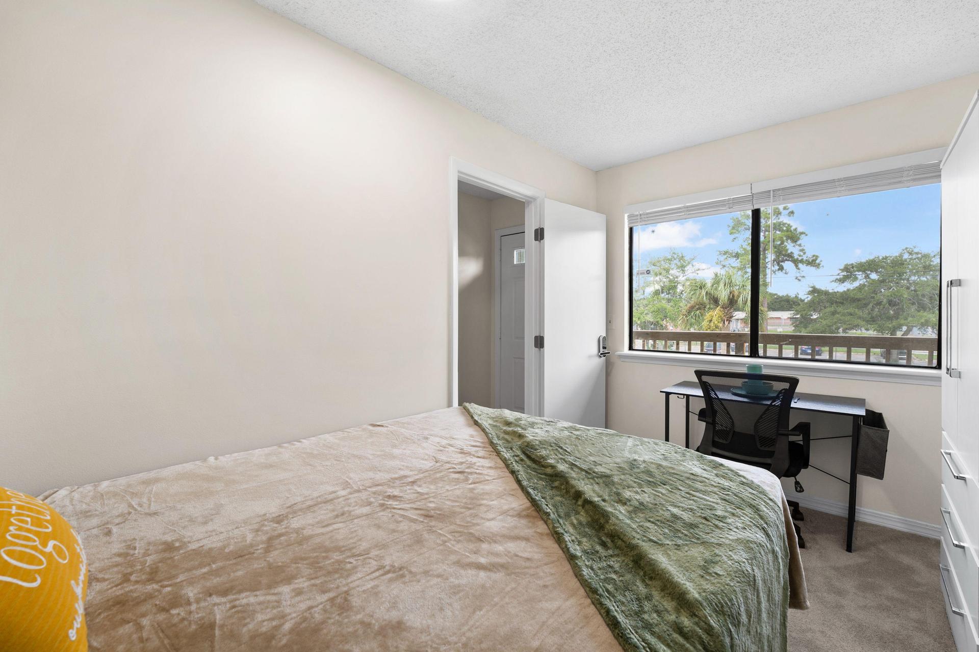 Queen bed with huge windows for natural sunlight