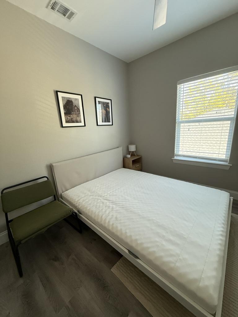 White sound machine and full size bed