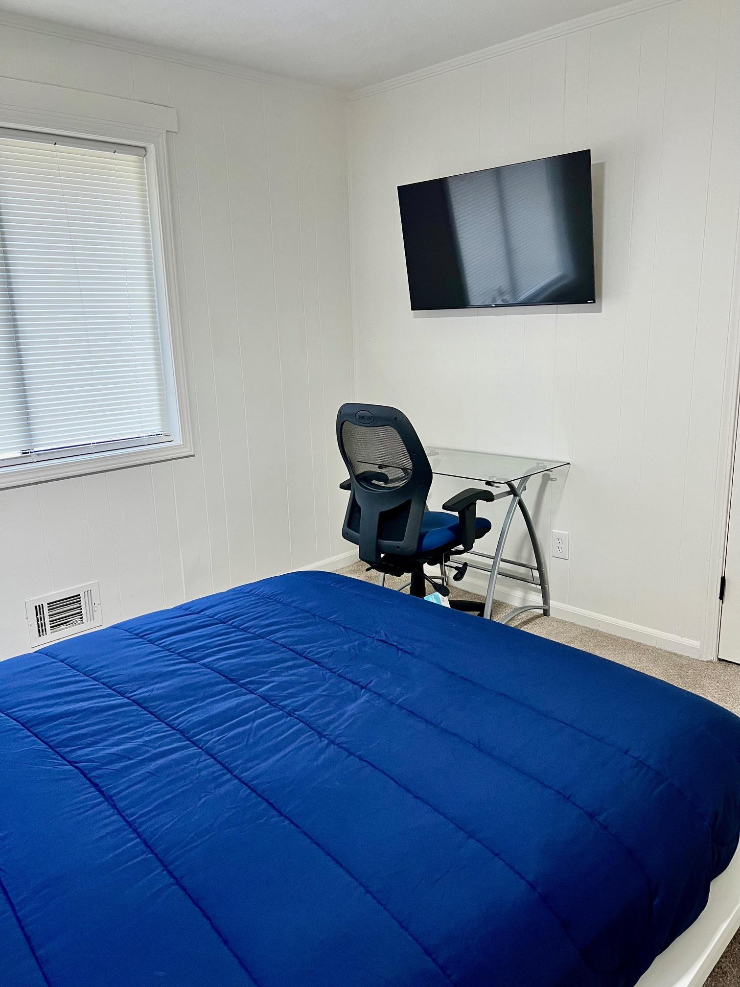 Room 2 Workstation with Flat screen TV next to closet