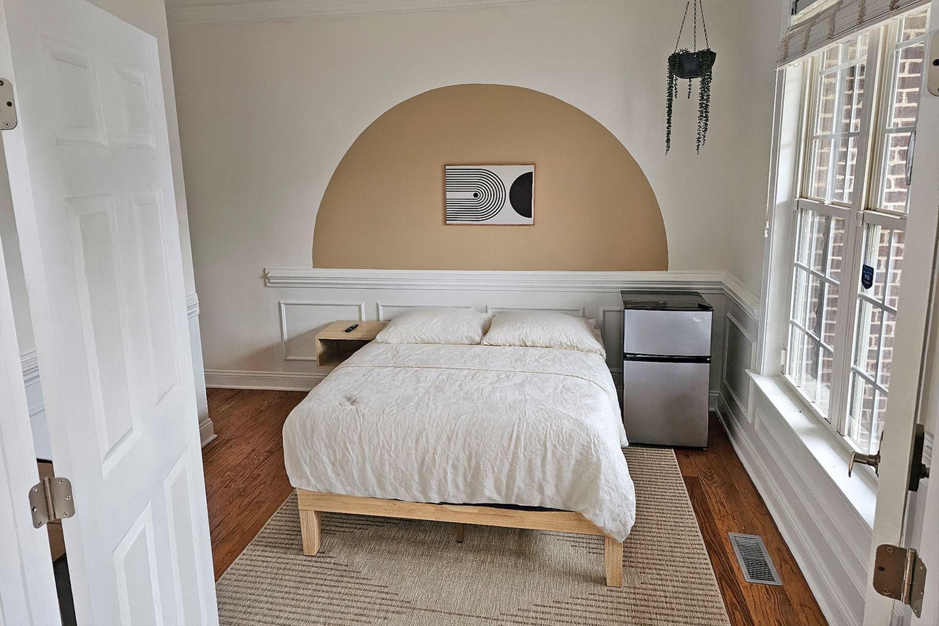 Room with a brand new smart TV, mini 2-door fridge, electric standing desk,  whisper-quiet fan and a closet.