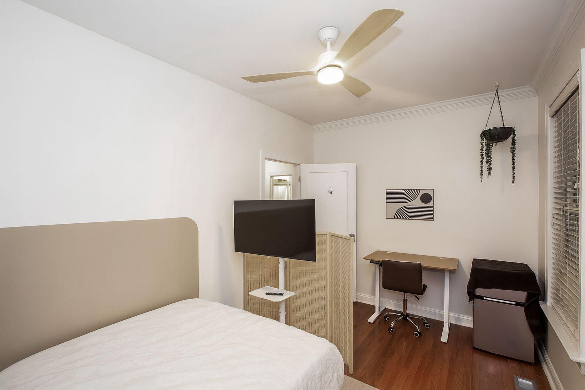 Room with a brand new smart TV, mini 2-door fridge, electric standing desk,  and a whisper-quiet fan. Also, has a fireplace.
