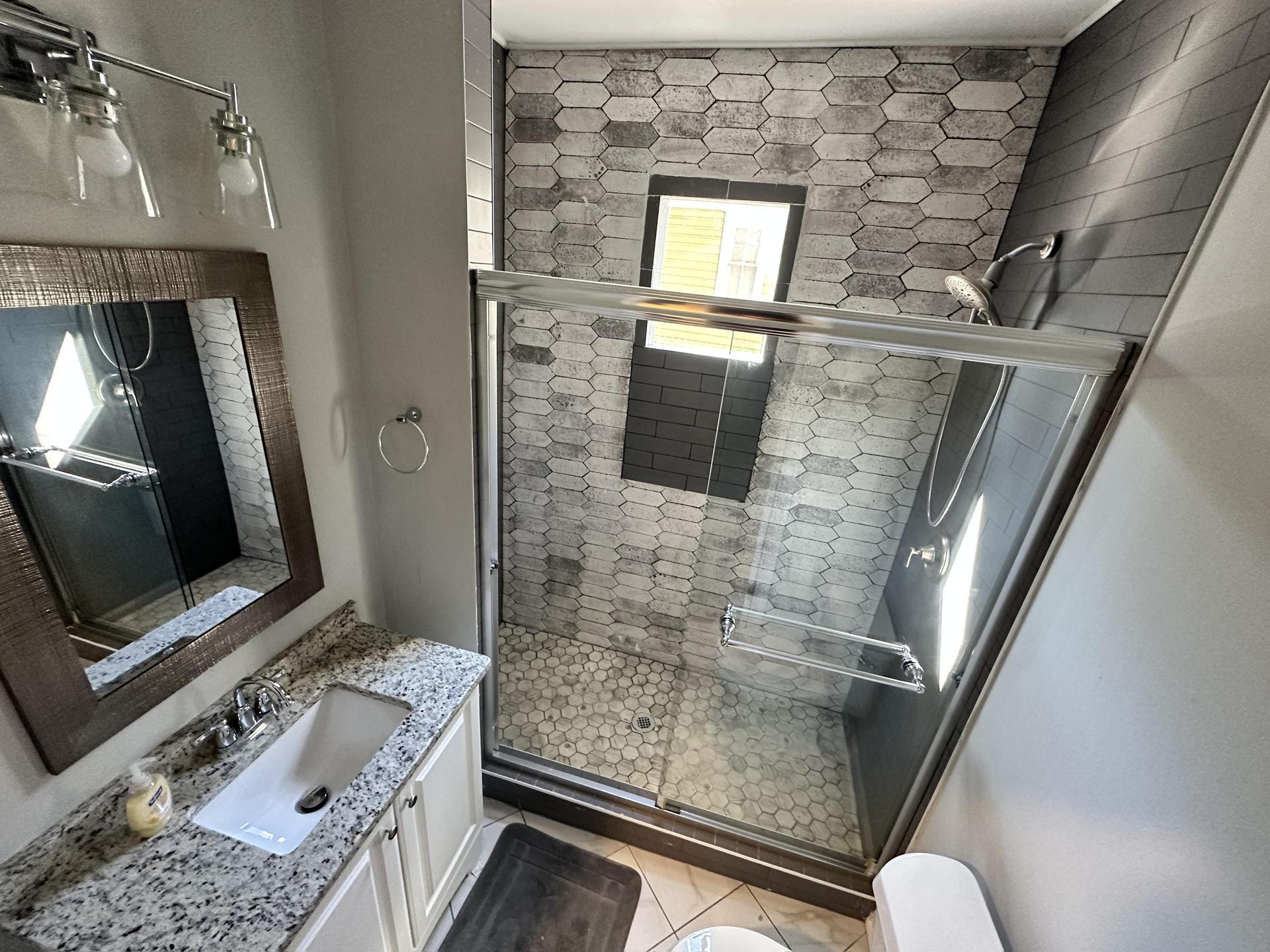 Tiled, shared full restroom.