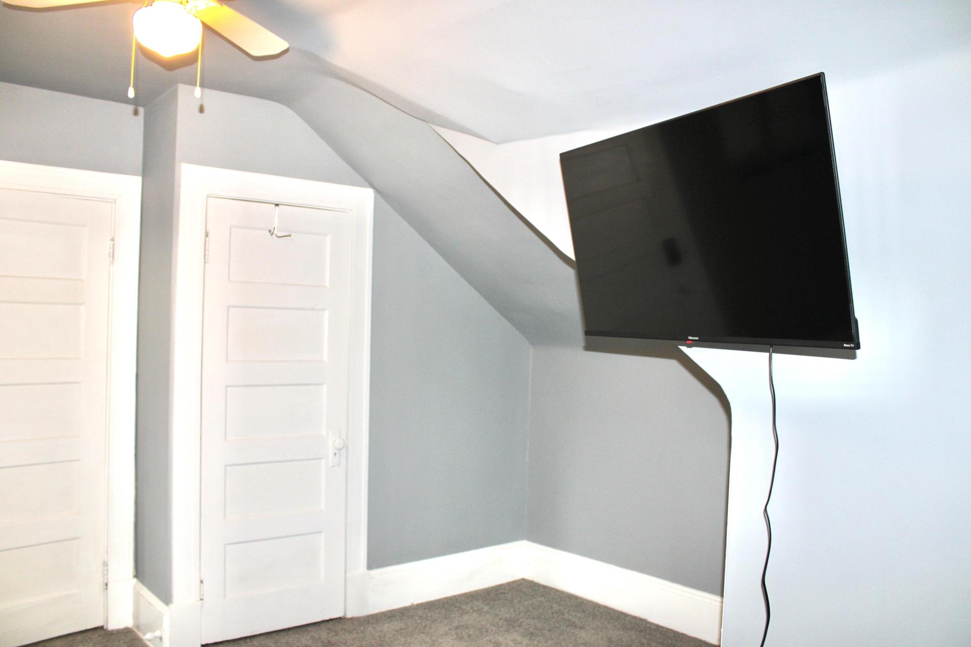 Mini studio apartment with full private bathroom, small kitchen, and living space, as well as separate bedroom.