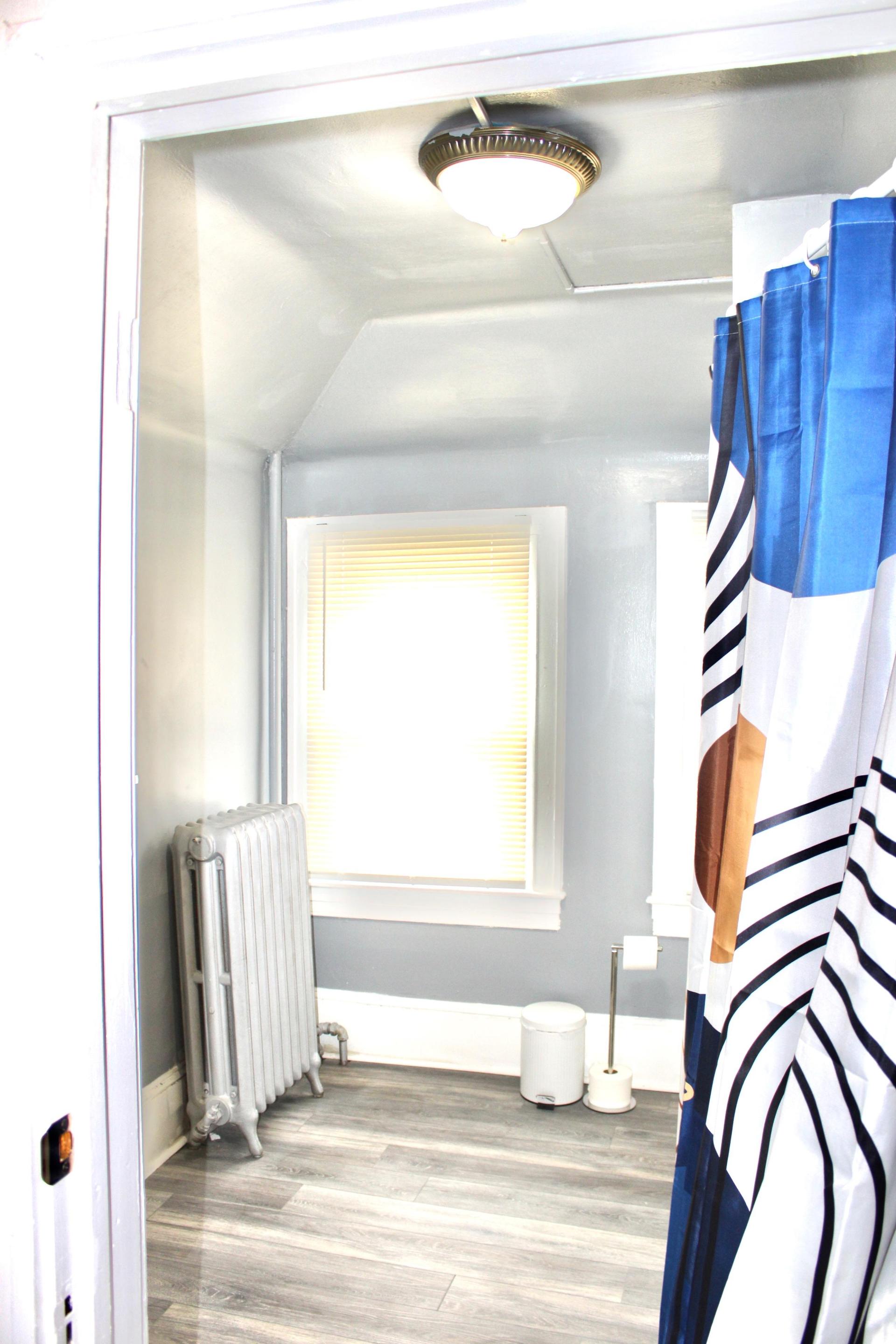 Mini studio apartment with full private bathroom, small kitchen, and living space, as well as separate bedroom.