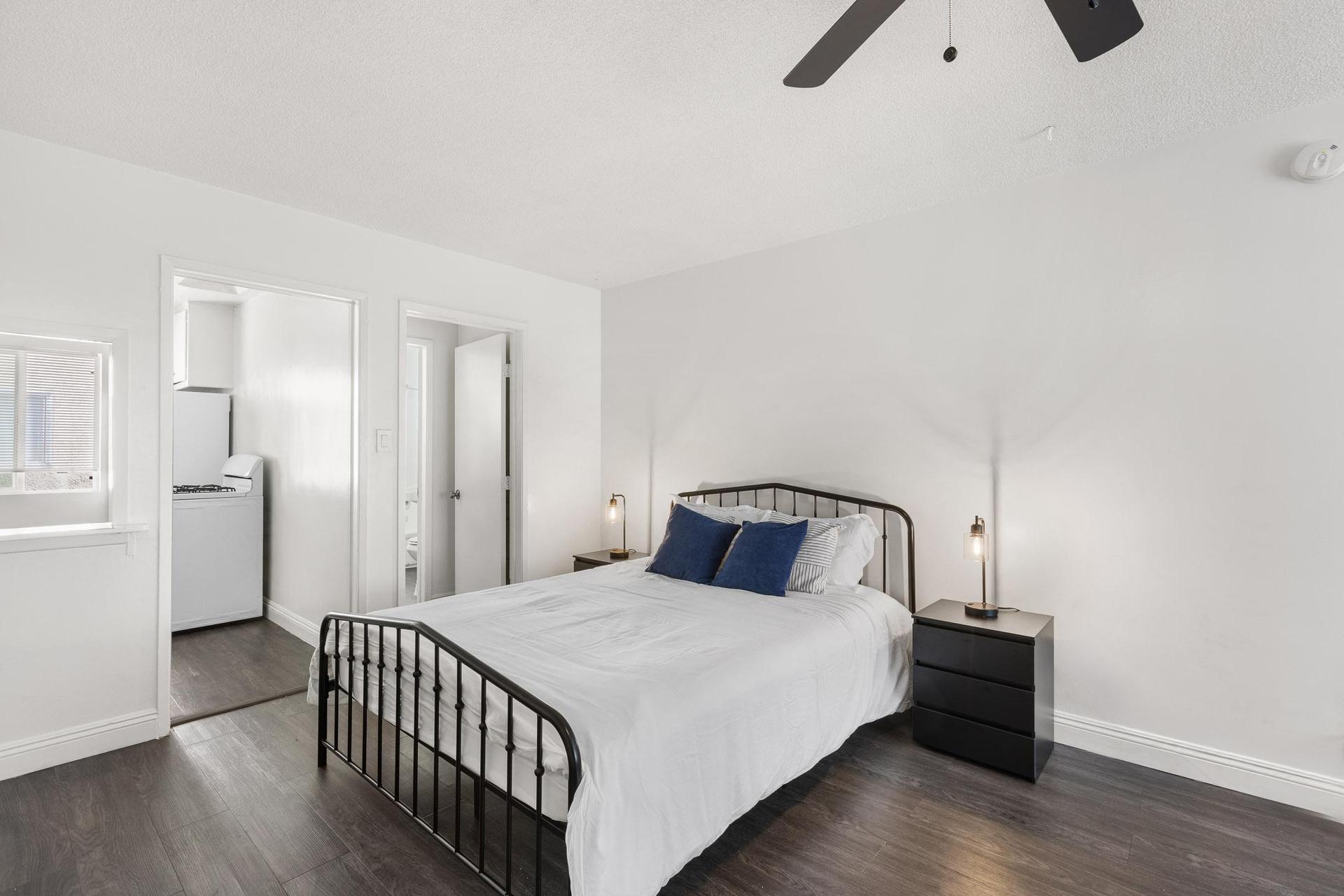 Bright bedroom with ceiling fan and cozy layout.