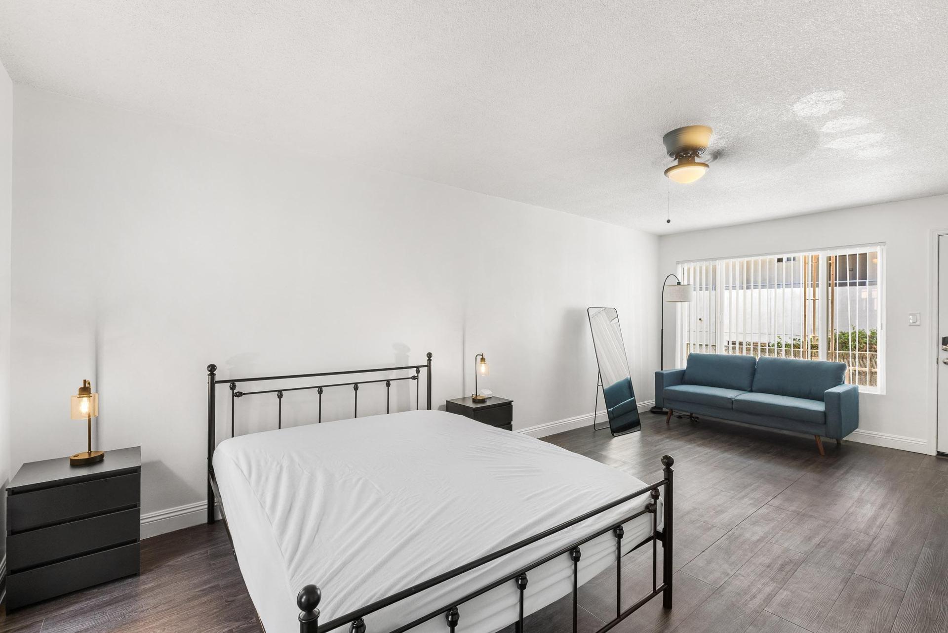 Bright bedroom with ceiling fan and cozy layout.